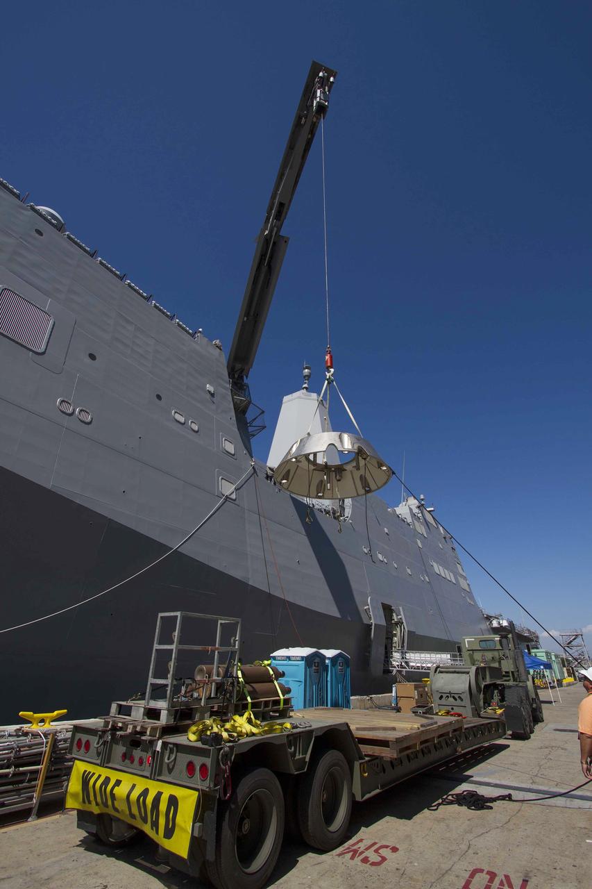 SAN DIEGO, Calif. – The USS Anchorage is docked at Naval Base San Diego during loading operations in its well deck for Orion Underway Recovery Test 3. A crane is used to lift the Orion forward bay cover for loading on the ship. The ship will head out to sea, off the coast of San Diego, in search of conditions to support test needs for a full dress rehearsal of recovery operations. NASA, Lockheed Martin and U.S. Navy personnel will conduct tests in the Pacific Ocean to prepare for recovery of the Orion crew module on its return from a deep space mission. The test will allow the teams to demonstrate and evaluate the recovery processes, procedures, new hardware and personnel in open waters.    The Ground Systems Development and Operations Program is conducting the underway recovery tests. Orion is the exploration spacecraft designed to carry astronauts to destinations not yet explored by humans, including an asteroid and Mars. It will have emergency abort capability, sustain the crew during space travel and provide safe re-entry from deep space return velocities. The first unpiloted test flight of Orion is scheduled to launch in 2014 atop a United Launch Alliance Delta IV Heavy rocket and in 2018 on NASA’s Space Launch System rocket. For more information, visit http://www.nasa.gov/orion. Photo credit: NASA/Cory Huston