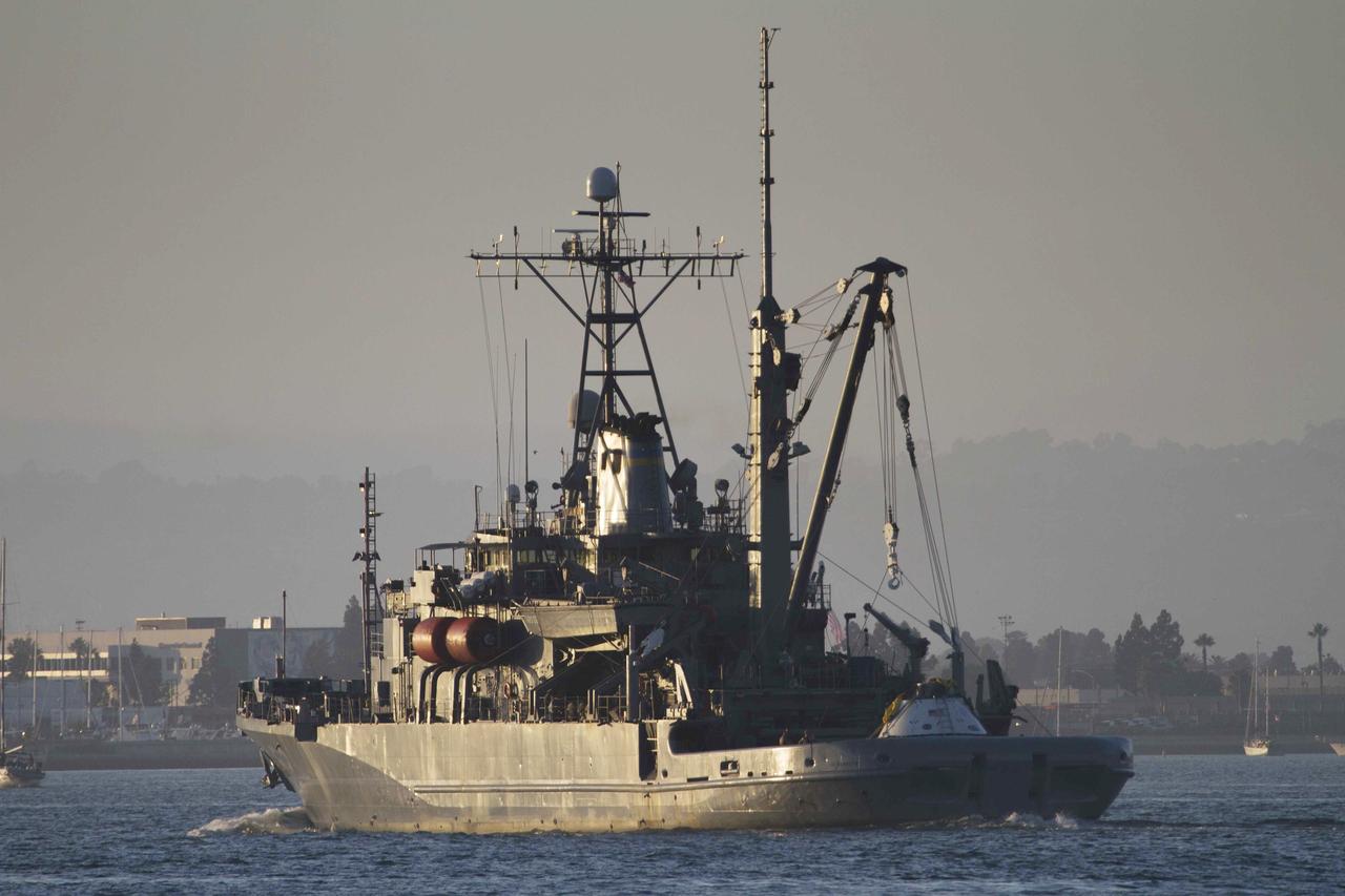 SAN DIEGO, Calif. – The USS Salvor, a safeguard-class rescue and salvage ship, departs from Naval Base San Diego on the first day of Orion Underway Recovery Test 4A. The Orion boilerplate test vehicle is in view on the ship. NASA, Lockheed Martin and the U.S. Navy will conduct alternate recovery methods using a stationary crane in the Pacific Ocean off the coast of San Diego to prepare for recovery of the Orion crew module on its return from a deep space mission. The underway recovery test allows the teams to demonstrate and evaluate recovery processes, procedures, new hardware and personnel in open waters.     The Ground Systems Development and Operations Program is conducting the underway recovery tests. Orion is the exploration spacecraft designed to carry astronauts to destinations not yet explored by humans, including an asteroid and Mars. It will have emergency abort capability, sustain the crew during space travel and provide safe re-entry from deep space return velocities. The first unpiloted test flight of Orion is scheduled to launch in 2014 atop a United Launch Alliance Delta IV Heavy rocket and in 2018 on NASA’s Space Launch System rocket. For more information, visit http://www.nasa.gov/orion. Photo credit: NASA/Cory Huston