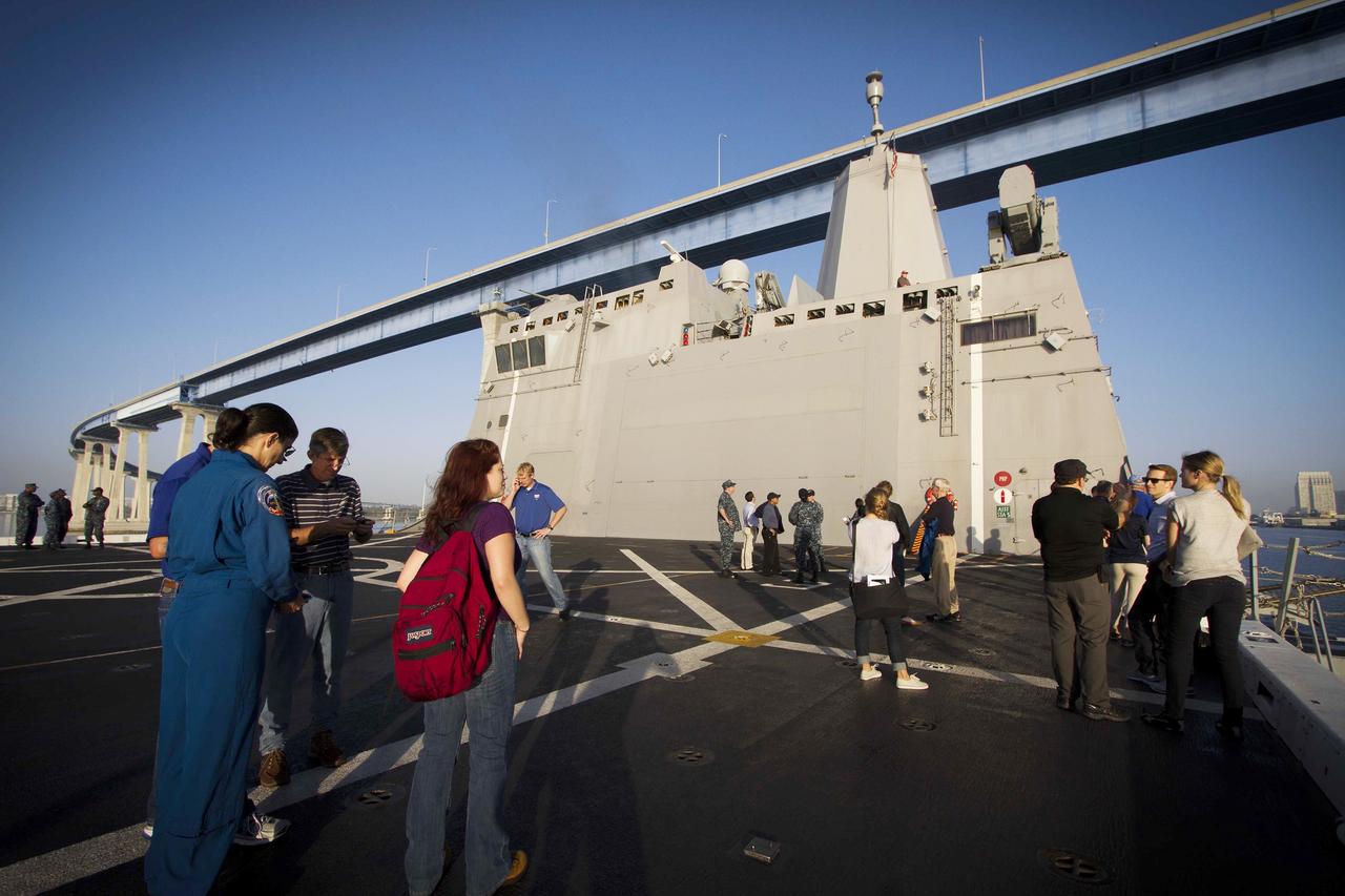 SAN DIEGO, Calif. – NASA, Lockheed Martin and U.S. Navy personnel stand on the deck of the USS Anchorage as the ship departs Naval Base San Diego on the first day of Orion Underway Recovery Test 3. The ship will head out to sea, off the coast of San Diego, in search of conditions to support test needs for a full dress rehearsal of recovery operations. NASA, Lockheed Martin and U.S. Navy personnel will conduct tests in the Pacific Ocean to prepare for recovery of the Orion crew module on its return from a deep space mission. The test will allow the teams to demonstrate and evaluate the recovery processes, procedures, hardware and personnel in open waters. The Ground Systems Development and Operations Program is conducting the underway recovery tests. Orion is the exploration spacecraft designed to carry astronauts to destinations not yet explored by humans, including an asteroid and Mars. It will have emergency abort capability, sustain the crew during space travel and provide safe re-entry from deep space return velocities. The first unpiloted test flight of Orion is scheduled to launch in 2014 atop a United Launch Alliance Delta IV Heavy rocket and in 2018 on NASA’s Space Launch System rocket. For more information, visit http://www.nasa.gov/orion. Photo credit: NASA/Cory Huston