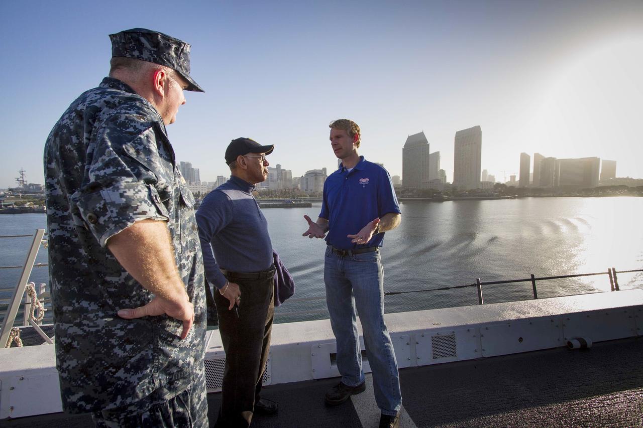 SAN DIEGO, Calif. – NASA Administrator Charlie Bolden, center, talks to NASA and U.S. Navy personnel on the deck of the USS Anchorage as the ship departs Naval Base San Diego on the first day of Orion Underway Recovery Test 3. The ship will head out to sea, off the coast of San Diego, in search of conditions to support test needs for a full dress rehearsal of recovery operations. NASA, Lockheed Martin and U.S. Navy personnel will conduct tests in the Pacific Ocean to prepare for recovery of the Orion crew module on its return from a deep space mission. The test will allow the teams to demonstrate and evaluate the recovery processes, procedures, hardware and personnel in open waters. The Ground Systems Development and Operations Program is conducting the underway recovery tests. Orion is the exploration spacecraft designed to carry astronauts to destinations not yet explored by humans, including an asteroid and Mars. It will have emergency abort capability, sustain the crew during space travel and provide safe re-entry from deep space return velocities. The first unpiloted test flight of Orion is scheduled to launch in 2014 atop a United Launch Alliance Delta IV Heavy rocket and in 2018 on NASA’s Space Launch System rocket. For more information, visit http://www.nasa.gov/orion. Photo credit: NASA/Cory Huston