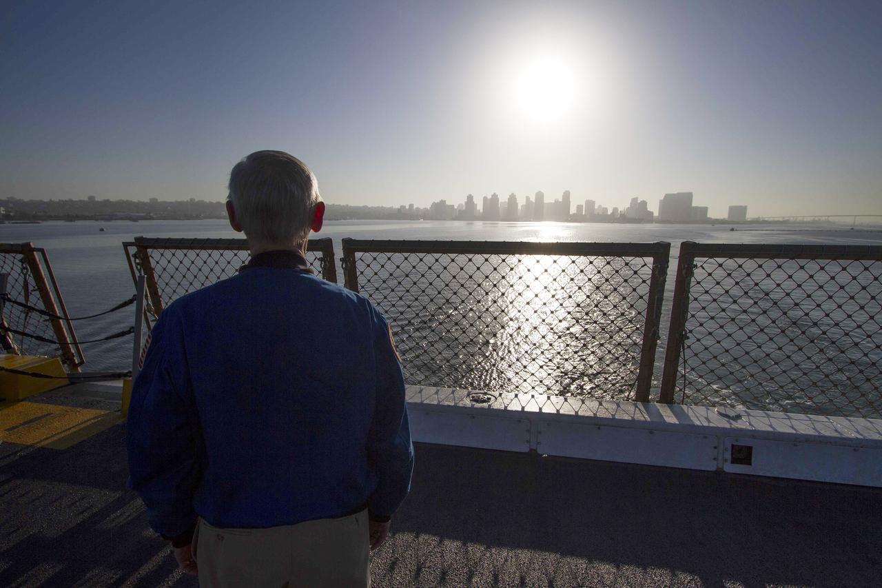 SAN DIEGO, Calif. – John Casper, retired NASA astronaut and Special Assistant for Program Integration for the Orion Program, looks at the San Diego skyline from the deck of the USS Anchorage as the ship departs Naval Base San Diego on the first day of Orion Underway Recovery Test 3. The ship will head out to sea, off the coast of San Diego, in search of conditions to support test needs for a full dress rehearsal of recovery operations. NASA, Lockheed Martin and U.S. Navy personnel will conduct tests in the Pacific Ocean to prepare for recovery of the Orion crew module on its return from a deep space mission. The test will allow the teams to demonstrate and evaluate the recovery processes, procedures, hardware and personnel in open waters.    The Ground Systems Development and Operations Program is conducting the underway recovery tests. Orion is the exploration spacecraft designed to carry astronauts to destinations not yet explored by humans, including an asteroid and Mars. It will have emergency abort capability, sustain the crew during space travel and provide safe re-entry from deep space return velocities. The first unpiloted test flight of Orion is scheduled to launch in 2014 atop a United Launch Alliance Delta IV Heavy rocket and in 2018 on NASA’s Space Launch System rocket. For more information, visit http://www.nasa.gov/orion. Photo credit: NASA/Cory Huston