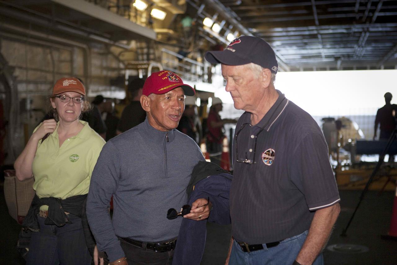 SAN DIEGO, Calif. – NASA Administrator Charlie Bolden, center, talks to Milt Heflin on the USS Anchorage on the first day of Orion Underway Recovery Test 3. Heflin was a former space shuttle flight director and Mission Operations executive with experience as a recovery engineer for several Apollo, Skylab and Apollo-Soyuz Test Project missions. At left is Brandi Dean, NASA Public Affairs Office. The ship will head out to sea, off the coast of San Diego, in search of conditions to support test needs for a full dress rehearsal of recovery operations. NASA, Lockheed Martin and U.S. Navy personnel will conduct tests in the Pacific Ocean to prepare for recovery of the Orion crew module on its return from a deep space mission. The test will allow the teams to demonstrate and evaluate the recovery processes, procedures, hardware and personnel in open waters.    The Ground Systems Development and Operations Program is conducting the underway recovery tests. Orion is the exploration spacecraft designed to carry astronauts to destinations not yet explored by humans, including an asteroid and Mars. It will have emergency abort capability, sustain the crew during space travel and provide safe re-entry from deep space return velocities. The first unpiloted test flight of Orion is scheduled to launch in 2014 atop a United Launch Alliance Delta IV Heavy rocket and in 2018 on NASA’s Space Launch System rocket. For more information, visit http://www.nasa.gov/orion. Photo credit: NASA/Cory Huston