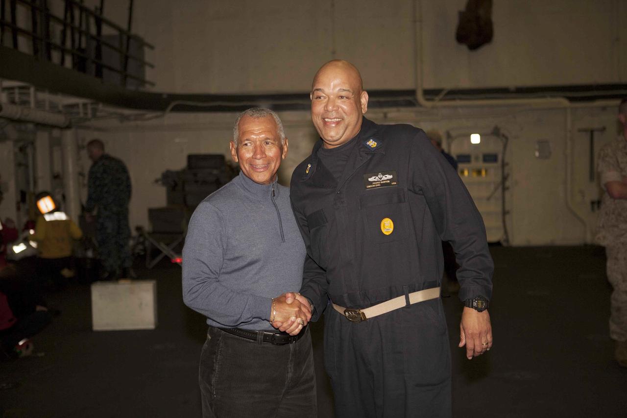 SAN DIEGO, Calif. – NASA Administrator Charlie Bolden, at left, talks to Pedro Santos, U.S. Navy, on the USS Anchorage. The ship will head out to sea, off the coast of San Diego, in search of conditions to support test needs for the first day of Orion Underway Recovery Test 3. NASA, Lockheed Martin and U.S. Navy personnel will conduct tests in the Pacific Ocean to prepare for recovery of the Orion crew module on its return from a deep space mission. The test will allow the teams to demonstrate and evaluate the recovery processes, procedures, hardware and personnel in open waters.    The Ground Systems Development and Operations Program is conducting the underway recovery tests. Orion is the exploration spacecraft designed to carry astronauts to destinations not yet explored by humans, including an asteroid and Mars. It will have emergency abort capability, sustain the crew during space travel and provide safe re-entry from deep space return velocities. The first unpiloted test flight of Orion is scheduled to launch in 2014 atop a United Launch Alliance Delta IV Heavy rocket and in 2018 on NASA’s Space Launch System rocket. For more information, visit http://www.nasa.gov/orion. Photo credit: NASA/Cory Huston