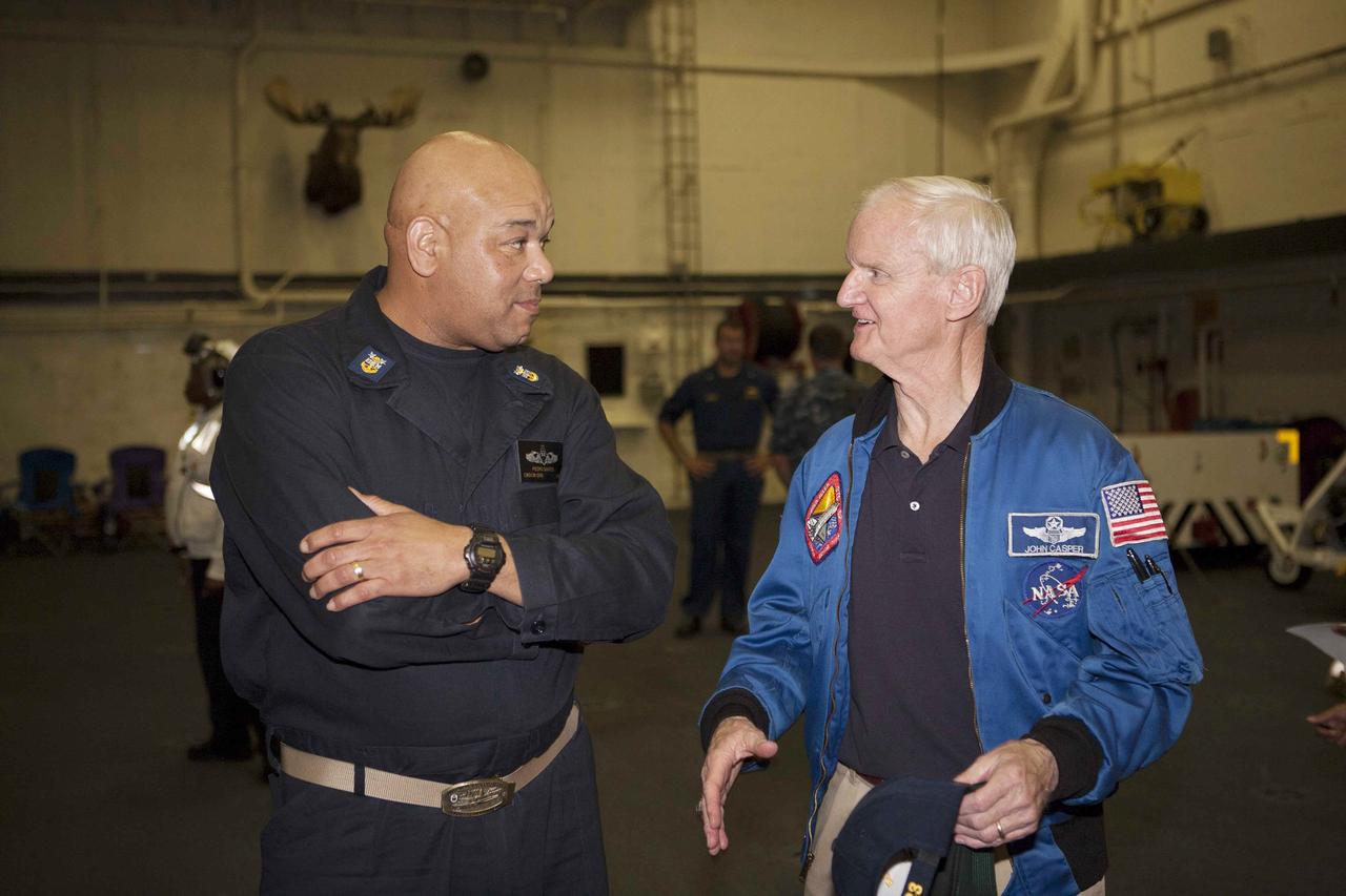 SAN DIEGO, Calif. – Pedro Santos, at left, with the U.S. Navy, talks to John Casper, retired NASA astronaut and Special Assistant for Program Integration for the Orion Program, on the USS Anchorage. The ship will head out to sea, off the coast of San Diego, in search of conditions to support test needs for the first day of Orion Underway Recovery Test 3. NASA, Lockheed Martin and U.S. Navy personnel will conduct tests in the Pacific Ocean to prepare for recovery of the Orion crew module on its return from a deep space mission. The test will allow the teams to demonstrate and evaluate the recovery processes, procedures, hardware and personnel in open waters.    The Ground Systems Development and Operations Program is conducting the underway recovery tests. Orion is the exploration spacecraft designed to carry astronauts to destinations not yet explored by humans, including an asteroid and Mars. It will have emergency abort capability, sustain the crew during space travel and provide safe re-entry from deep space return velocities. The first unpiloted test flight of Orion is scheduled to launch in 2014 atop a United Launch Alliance Delta IV Heavy rocket and in 2018 on NASA’s Space Launch System rocket. For more information, visit http://www.nasa.gov/orion. Photo credit: NASA/Cory Huston
