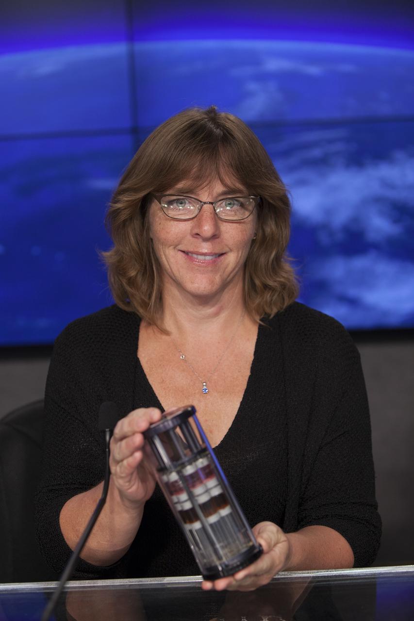 CAPE CANAVERAL, Fla. – Shiela Neilsen, principal investigator, Micro-8, University of Montana, briefs media representatives in Kennedy Space Center’s Press Site auditorium in preparation for the launch of the SpaceX CRS-4 mission to resupply the International Space Station. Neilsen is a member of the ISS Science Panel on Model Organisms.    The mission is the fourth of 12 SpaceX flights NASA contracted with the company to resupply the space station. It will be the fifth trip by a Dragon spacecraft to the orbiting laboratory. The spacecraft’s 2.5 tons of supplies, science experiments, and technology demonstrations include critical materials to support 255 science and research investigations that will occur during the station's Expeditions 41 and 42. Liftoff is targeted for an instantaneous window at 2:14 a.m. EDT. To learn more about the mission, visit http://www.nasa.gov/mission_pages/station/structure/launch/index.html. Photo credit: NASA/Jim Grossmann