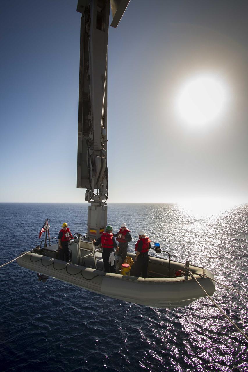 SAN DIEGO, Calif. – A rigid hull inflatable boat, with U.S. Navy personnel aboard, is being lowered into the water from the USS Anchorage on the second day of Orion Underway Recovery Test 3 in the Pacific Ocean. NASA, Lockheed Martin and U.S. Navy personnel are conducting recovery tests using the Orion boilerplate test vehicle to prepare for recovery of the Orion crew module on its return from a deep space mission. The test allows the teams to demonstrate and evaluate the recovery processes, procedures, hardware and personnel in open waters.    The Ground Systems Development and Operations Program is conducting the underway recovery tests. Orion is the exploration spacecraft designed to carry astronauts to destinations not yet explored by humans, including an asteroid and Mars. It will have emergency abort capability, sustain the crew during space travel and provide safe re-entry from deep space return velocities. The first unpiloted test flight of Orion is scheduled to launch in 2014 atop a United Launch Alliance Delta IV Heavy rocket and in 2018 on NASA’s Space Launch System rocket. For more information, visit http://www.nasa.gov/orion. Photo credit: NASA/Cory Huston