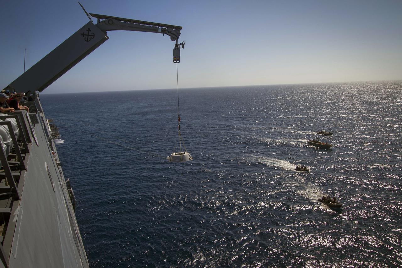 SAN DIEGO, Calif. – A mock-up of the Orion forward bay cover is being lowered by crane from the USS Anchorage into the water during the second day of Orion Underway Recovery Test 3 in the Pacific Ocean. NASA, Lockheed Martin and U.S. Navy personnel are conducting the recovery test using the Orion boilerplate test vehicle and mock-up forward bay cover to prepare for recovery of the Orion crew module on its return from a deep space mission. The test allows the teams to demonstrate and evaluate the recovery processes, procedures, hardware and personnel in open waters.    The Ground Systems Development and Operations Program is conducting the underway recovery tests. Orion is the exploration spacecraft designed to carry astronauts to destinations not yet explored by humans, including an asteroid and Mars. It will have emergency abort capability, sustain the crew during space travel and provide safe re-entry from deep space return velocities. The first unpiloted test flight of Orion is scheduled to launch in 2014 atop a United Launch Alliance Delta IV Heavy rocket and in 2018 on NASA’s Space Launch System rocket. For more information, visit http://www.nasa.gov/orion. Photo credit: NASA/Cory Huston