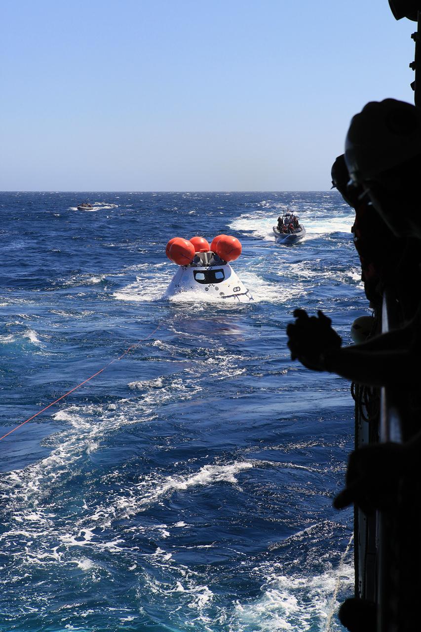 SAN DIEGO, Calif. – During the third day of Orion Underway Recovery Test 3 on the USS Anchorage in the Pacific Ocean, U.S. Navy personnel in a rigid hull inflatable boat use tether lines attached to the test vehicle to practice the recovery process. NASA, Lockheed Martin and U.S. Navy personnel are conducting recovery tests using the Orion boilerplate test vehicle to prepare for recovery of the Orion crew module on its return from a deep space mission. The test allows the teams to demonstrate and evaluate the recovery processes, procedures, hardware and personnel in open waters. The Ground Systems Development and Operations Program is conducting the underway recovery tests. Orion is the exploration spacecraft designed to carry astronauts to destinations not yet explored by humans, including an asteroid and Mars. It will have emergency abort capability, sustain the crew during space travel and provide safe re-entry from deep space return velocities. The first unpiloted test flight of Orion is scheduled to launch in 2014 atop a United Launch Alliance Delta IV Heavy rocket and in 2018 on NASA’s Space Launch System rocket. For more information, visit http://www.nasa.gov/orion. Photo credit: NASA/Kim Shiflett
