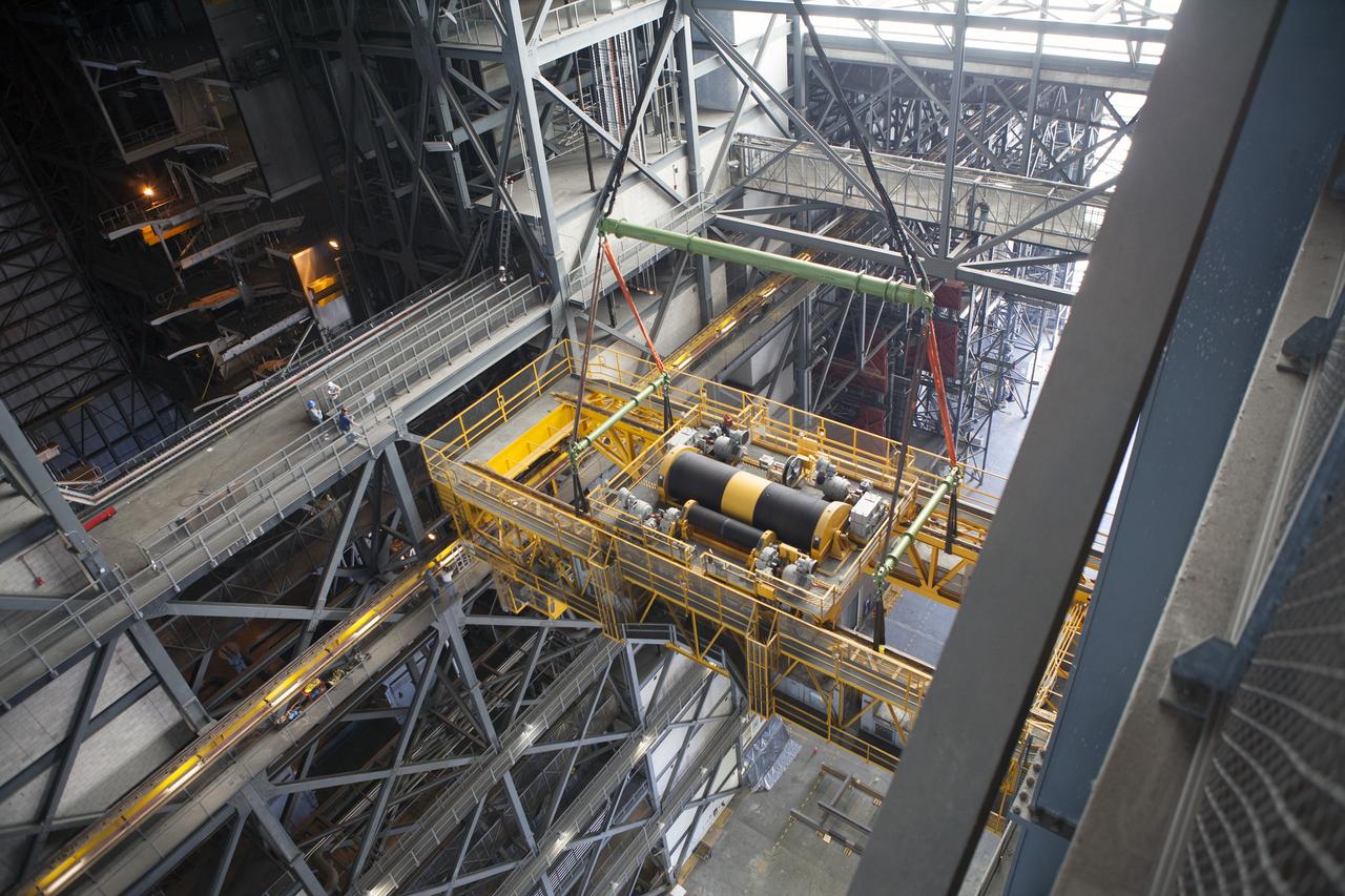 CAPE CANAVERAL, Fla. – Inside the Vehicle Assembly Building, or VAB, at NASA's Kennedy Space Center in Florida, a view from above shows a crane being used to lower the 175-ton crane. The crane is being lowered from Level 16 down to the transfer aisle floor to perform upgrades to its 45-year-old controls in order to improve reliability, precision and safety. The Ground Systems Development and Operations Program is overseeing upgrades and modifications to the VAB. The crane will be upgraded so that it can support lifting needs for NASA and other exploration vehicles, including the agency's Space Launch System and Orion spacecraft. Photo credit: NASA/Daniel Casper