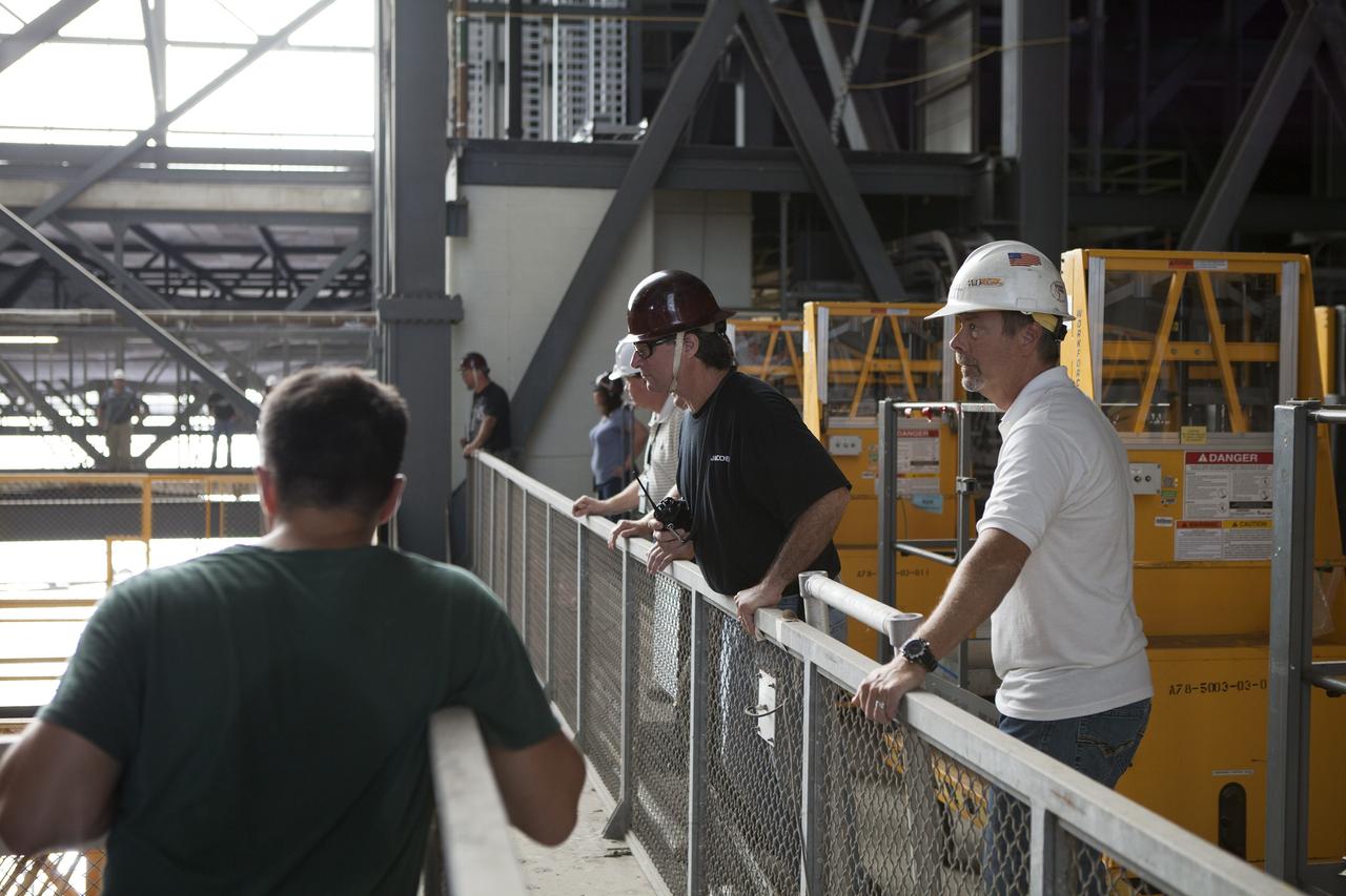 CAPE CANAVERAL, Fla. – Inside the Vehicle Assembly Building, or VAB, at NASA's Kennedy Space Center in Florida, NASA and contractor workers monitor the progress as the 175-ton crane is being lowered from Level 16 down to the transfer aisle floor. Upgrades to the crane's 45-year-old controls will be performed in order to improve reliability, precision and safety. The Ground Systems Development and Operations Program is overseeing upgrades and modifications to the VAB. The crane will be upgraded so that it can support lifting needs for NASA and other exploration vehicles, including the agency's Space Launch System and Orion spacecraft. Photo credit: NASA/Daniel Casper
