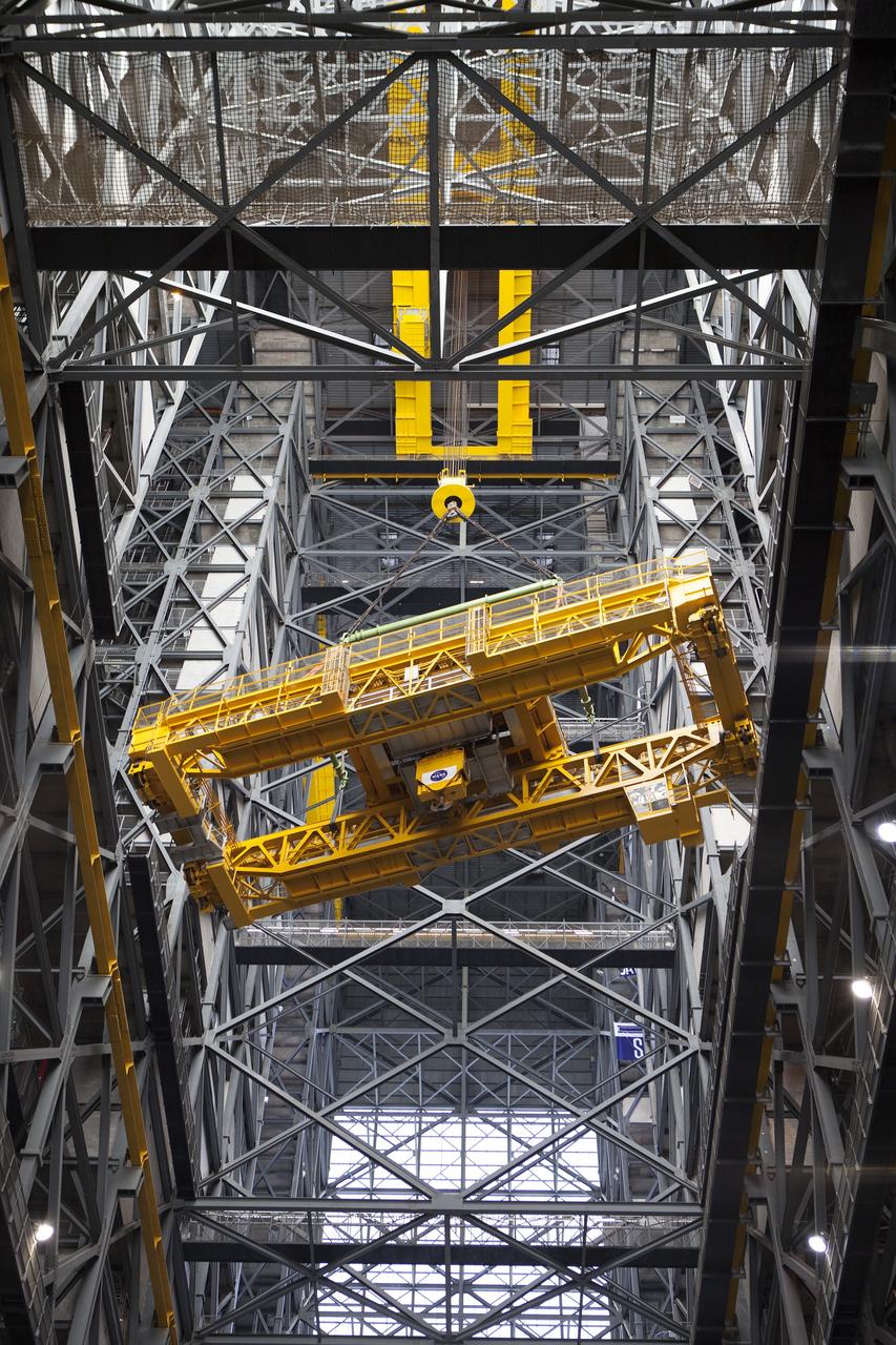 CAPE CANAVERAL, Fla. – Inside the Vehicle Assembly Building, or VAB, at NASA's Kennedy Space Center in Florida, the 175-ton crane is being turned as it is lowered by crane from Level 16 down to the transfer aisle floor. Upgrades to the crane's 45-year-old controls will be performed in order to improve reliability, precision and safety. The Ground Systems Development and Operations Program is overseeing upgrades and modifications to the VAB. The crane will be upgraded so that it can support lifting needs for NASA and other exploration vehicles, including the agency's Space Launch System and Orion spacecraft. Photo credit: NASA/Daniel Casper