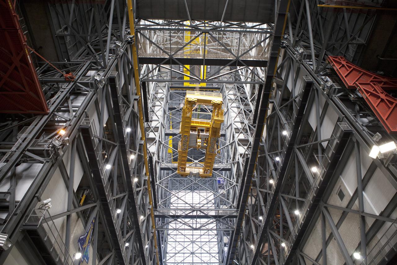 CAPE CANAVERAL, Fla. – Inside the Vehicle Assembly Building, or VAB, at NASA's Kennedy Space Center in Florida, the 175-ton crane has been turned as it is lowered by crane from Level 16 down to the transfer aisle floor. Upgrades to the crane's 45-year-old controls will be performed in order to improve reliability, precision and safety. The Ground Systems Development and Operations Program is overseeing upgrades and modifications to the VAB. The crane will be upgraded so that it can support lifting needs for NASA and other exploration vehicles, including the agency's Space Launch System and Orion spacecraft. Photo credit: NASA/Daniel Casper