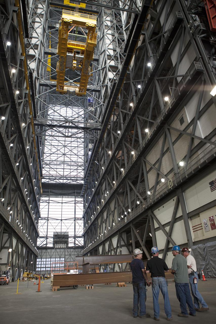 CAPE CANAVERAL, Fla. – Inside the Vehicle Assembly Building, or VAB, at NASA's Kennedy Space Center in Florida, the 175-ton crane has been turned as it is lowered by crane from Level 16 down to the transfer aisle floor. Upgrades to the crane's 45-year-old controls will be performed in order to improve reliability, precision and safety. The Ground Systems Development and Operations Program is overseeing upgrades and modifications to the VAB. The crane will be upgraded so that it can support lifting needs for NASA and other exploration vehicles, including the agency's Space Launch System and Orion spacecraft. Photo credit: NASA/Daniel Casper