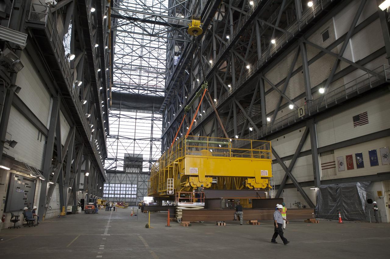 CAPE CANAVERAL, Fla. – Inside the Vehicle Assembly Building, or VAB, at NASA's Kennedy Space Center in Florida, the 175-ton crane has been lowered by crane onto steel stands on the transfer aisle floor. The crane was lowered from Level 16. Upgrades to the crane's 45-year-old controls will be performed in order to improve reliability, precision and safety. The Ground Systems Development and Operations Program is overseeing upgrades and modifications to the VAB. The crane will be upgraded so that it can support lifting needs for NASA and other exploration vehicles, including the agency's Space Launch System and Orion spacecraft. Photo credit: NASA/Daniel Casper