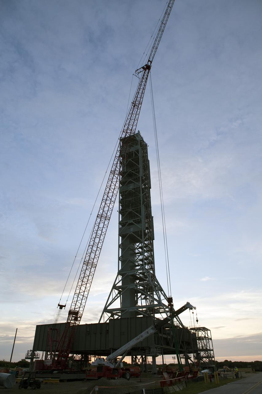 CAPE CANAVERAL, Fla. – In the early morning at NASA's Kennedy Space Center in Florida, preparations are underway to lift the final large steel beam for installation on the base of the Mobile Launcher, or ML, at the Mobile Launcher Park Site. The ML is being modified and strengthened to accommodate the weight, size and thrust at launch of NASA's Space Launch System, or SLS, and Orion spacecraft.    In 2013, the agency awarded a contract to J.P. Donovan Construction Inc. of Rockledge, Fla., to modify the ML, which is one of the key elements of ground support equipment that is being upgraded by the Ground Systems Development and Operations Program at Kennedy. The existing 24-foot exhaust hole is being enlarged and strengthened for the larger, heavier SLS rocket. The ML will carry the SLS rocket and Orion spacecraft to Launch Pad 39B for its first uncrewed mission, Exploration Mission-1, in 2018. Photo credit: NASA/Daniel Casper