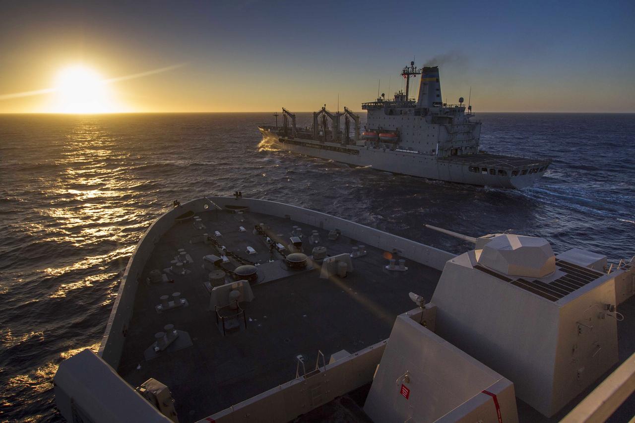 SAN DIEGO, Calif. – The USNS Yukon, in the foreground, is stationed nearby the USS Anchorage, during the third day of Orion Underway Recovery Test 3 in the Pacific Ocean. The Yukon provides underway replenishment of fuel to ships at sea. U.S. Navy divers and other personnel completed a day of practicing recovery of the Orion boilerplate test vehicle. NASA, Lockheed Martin and U.S. Navy personnel are conducting the recovery test using the test vehicle to prepare for recovery of the Orion crew module on its return from a deep space mission. The test allows the teams to demonstrate and evaluate the recovery processes, procedures, hardware and personnel in open waters. The Ground Systems Development and Operations Program is conducting the underway recovery tests. Orion is the exploration spacecraft designed to carry astronauts to destinations not yet explored by humans, including an asteroid and Mars. It will have emergency abort capability, sustain the crew during space travel and provide safe re-entry from deep space return velocities. The first unpiloted test flight of Orion is scheduled to launch in 2014 atop a United Launch Alliance Delta IV Heavy rocket and in 2018 on NASA’s Space Launch System rocket. For more information, visit http://www.nasa.gov/orion. Photo credit: NASA/Cory Huston