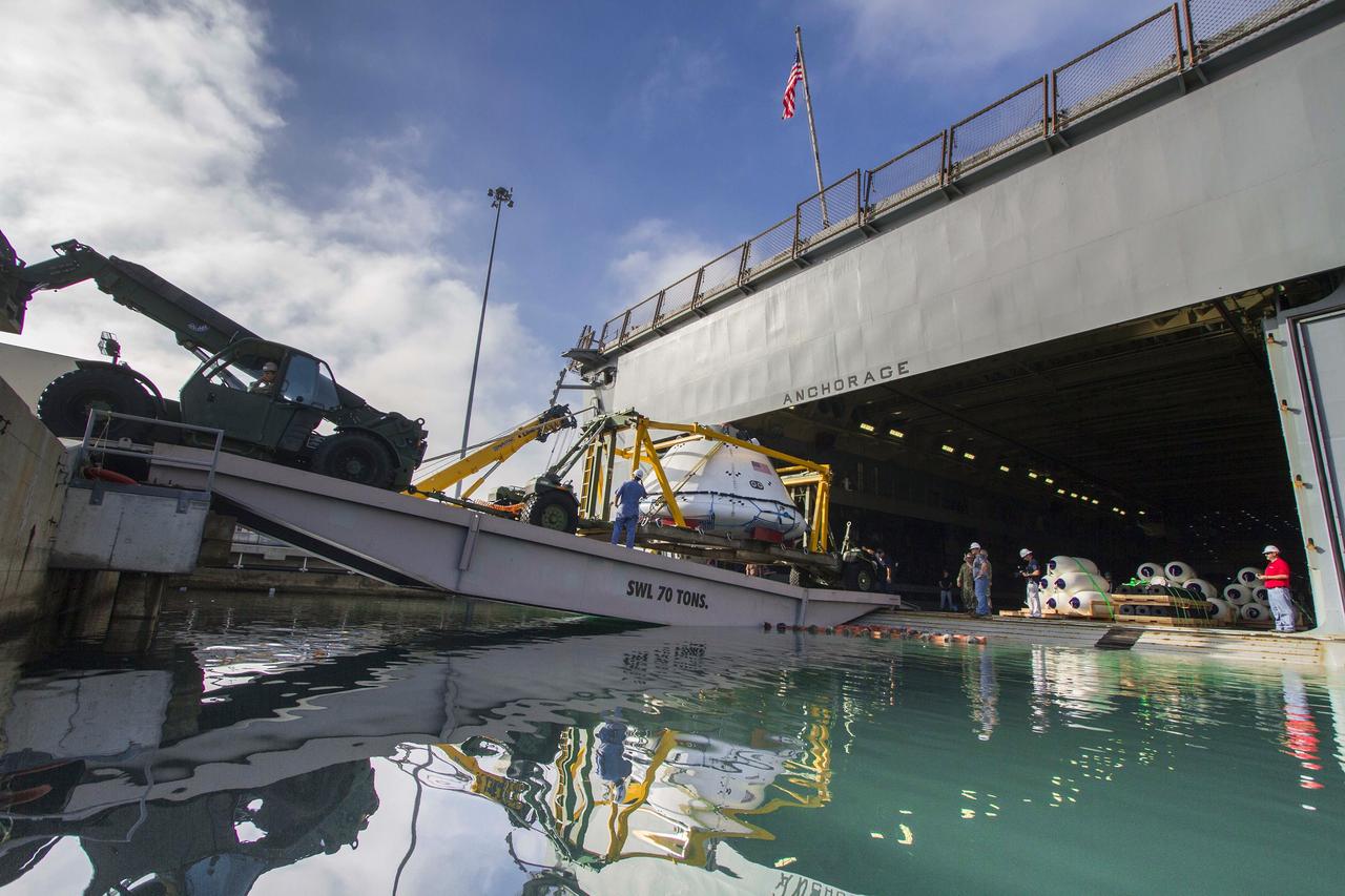 SAN DIEGO, Calif. – The Orion boilerplate test vehicle and support equipment are being offloaded from the well deck of the USS Anchorage at Naval Base San Diego following completion of Underway Recovery Test 3 in the Pacific Ocean.     NASA, Lockheed Martin and U.S. Navy personnel conducted the recovery test using the test vehicle to prepare for recovery of the Orion crew module on its return from a deep space mission. The test allowed the teams to demonstrate and evaluate the recovery processes, procedures, hardware and personnel in open waters. The Ground Systems Development and Operations Program conducted the underway recovery tests. Orion is the exploration spacecraft designed to carry astronauts to destinations not yet explored by humans, including an asteroid and Mars. It will have emergency abort capability, sustain the crew during space travel and provide safe re-entry from deep space return velocities. The first unpiloted test flight of Orion is scheduled to launch in 2014 atop a United Launch Alliance Delta IV Heavy rocket and in 2018 on NASA’s Space Launch System rocket. For more information, visit http://www.nasa.gov/orion. Photo credit: NASA/Cory Huston
