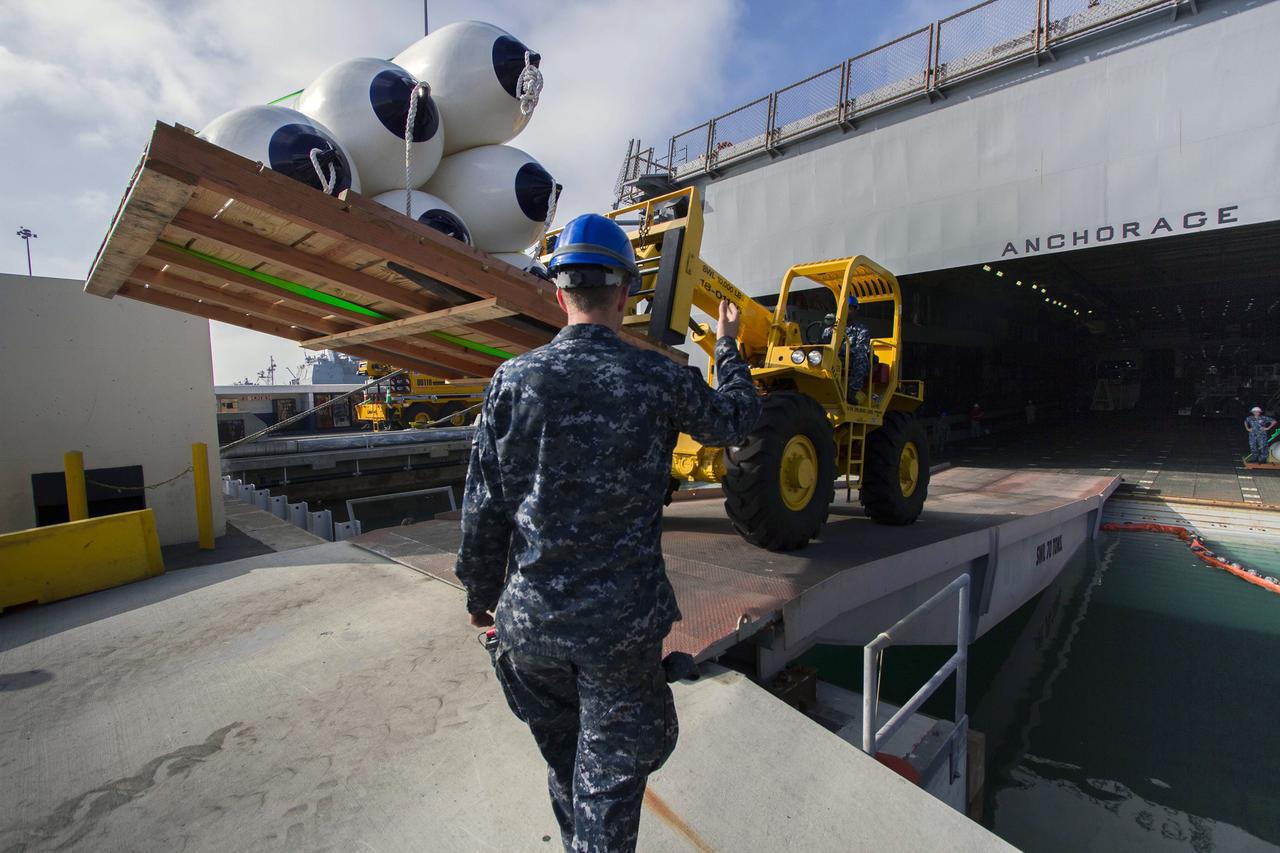 SAN DIEGO, Calif. – Support equipment is being offloaded from the well deck of the USS Anchorage at Naval Base San Diego following completion of Underway Recovery Test 3 on the Orion boilerplate test vehicle in the Pacific Ocean. NASA, Lockheed Martin and U.S. Navy personnel conducted the recovery test using the test vehicle to prepare for recovery of the Orion crew module on its return from a deep space mission. The test allowed the teams to demonstrate and evaluate the recovery processes, procedures, hardware and personnel in open waters. The Ground Systems Development and Operations Program conducted the underway recovery tests. Orion is the exploration spacecraft designed to carry astronauts to destinations not yet explored by humans, including an asteroid and Mars. It will have emergency abort capability, sustain the crew during space travel and provide safe re-entry from deep space return velocities. The first unpiloted test flight of Orion is scheduled to launch in 2014 atop a United Launch Alliance Delta IV Heavy rocket and in 2018 on NASA’s Space Launch System rocket. For more information, visit http://www.nasa.gov/orion. Photo credit: NASA/Cory Huston