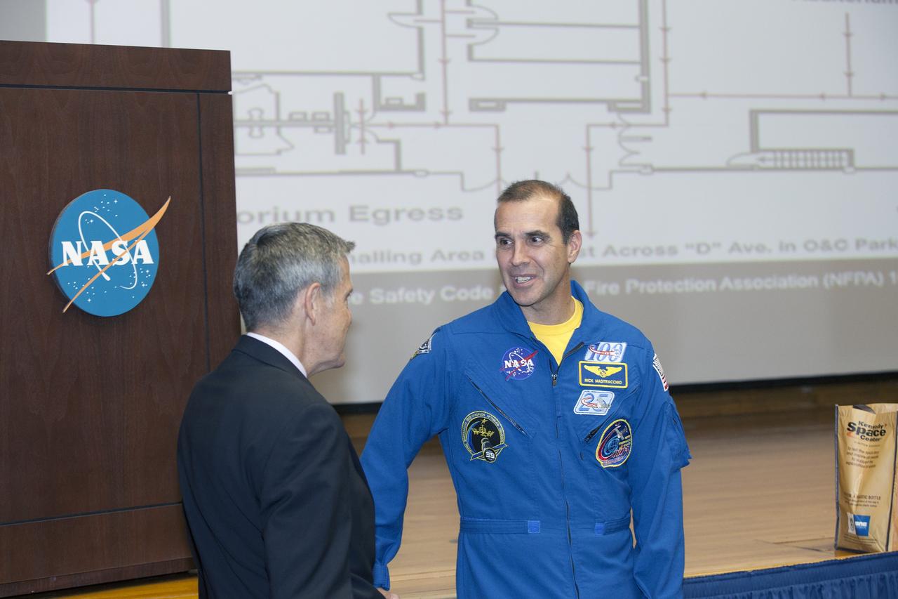 CAPE CANAVERAL, Fla. – NASA Kennedy Space Center Director and former astronaut Bob Cabana, left, greets astronaut Rick Mastracchio before the start of a post-flight presentation on the Expedition 38 mission to the International Space Station.    The Space Flight Awareness Program hosted Mastracchio's presentation for employees in the KSC Training Auditorium. An Expedition 38/39 crew member, Mastracchio launched to the station from the Baikonur Cosmodrome in Kazakhstan on Nov. 6, 2013, and returned to Earth on May 13, 2014, after 188 days in space. Following Mastracchio's remarks, employees were given the opportunity to ask questions and to meet him in person. To read Mastracchio's biography, visit http://www.jsc.nasa.gov/Bios/htmlbios/mastracc.html. For more information on Expedition 38, visit http://www.nasa.gov/mission_pages/station/expeditions/expedition38. Photo credit: NASA/Daniel Casper