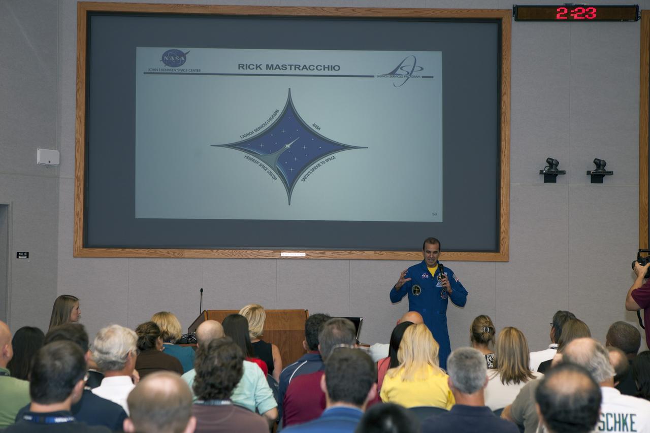 CAPE CANAVERAL, Fla. – NASA astronaut Rick Mastracchio recounts his experiences conducting the Slosh experiment on the International Space Station to employees attending the Launch Services Program's All Hands meeting in the Neil Armstrong Operations and Checkout Building Mission Briefing Room at NASA's Kennedy Space Center in Florida.    An Expedition 38/39 crew member, Mastracchio launched to the station from the Baikonur Cosmodrome in Kazakhstan on Nov. 6, 2013, and returned to Earth on May 13, 2014, after 188 days in space. To read Mastracchio's biography, visit http://www.jsc.nasa.gov/Bios/htmlbios/mastracc.html. For more information on the Slosh experiment, visit http://www.nasa.gov/content/slosh-experiment-designed-to-improve-rocket-safety-efficiency/. Photo credit: NASA/Daniel Casper