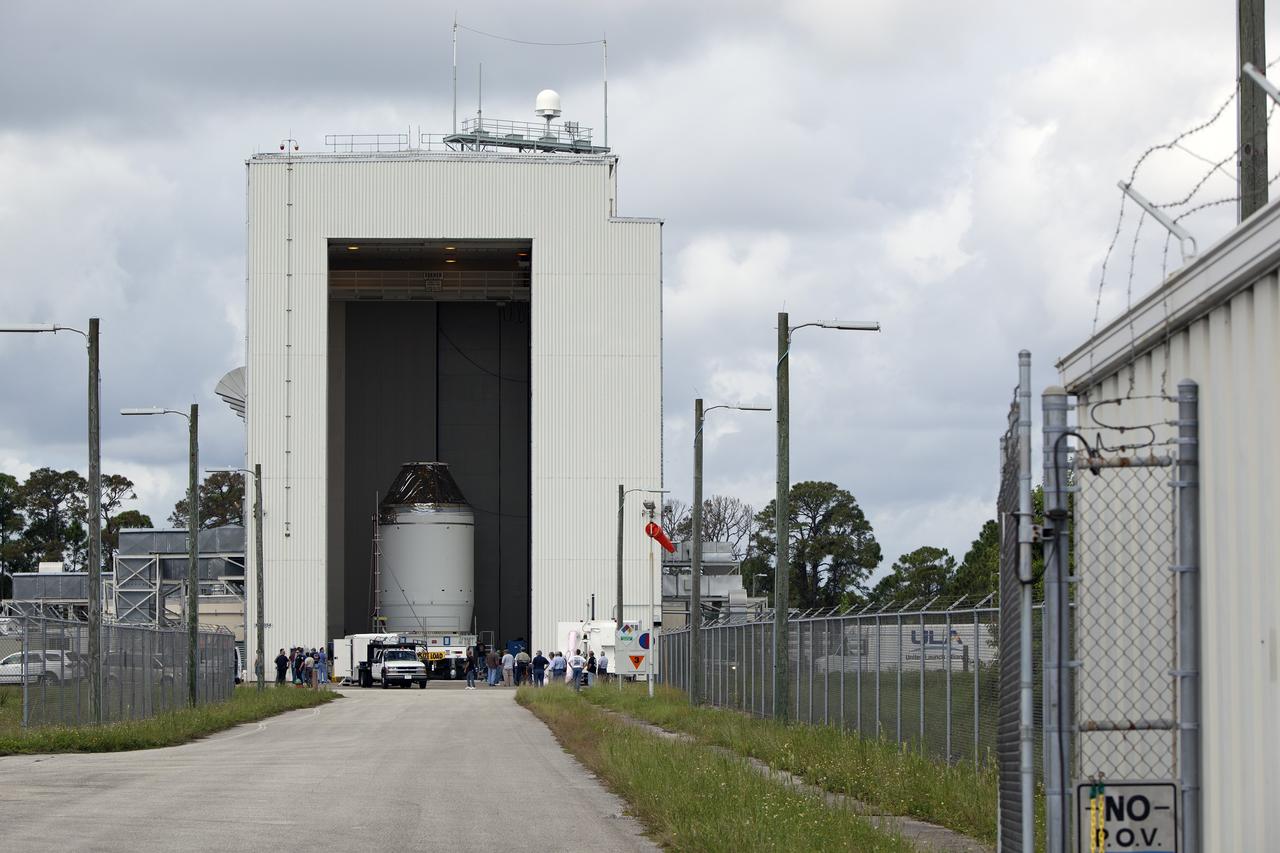 CAPE CANAVERAL, Fla. – The Orion crew module, stacked atop its service module, is prepared for its move out of the Payload Hazardous Servicing Facility, or PHSF, to the Launch Abort System Facility, or LASF, at NASA's Kennedy Space Center in Florida. The spacecraft for Exploration Flight Test-1 was fueled in the PHSF. Inside the LASF, the Launch Abort System will be installed around the Orion spacecraft ahead of its December flight test.    Orion is the exploration spacecraft designed to carry astronauts to destinations not yet explored by humans, including an asteroid and Mars. It will have emergency abort capability, sustain the crew during space travel and provide safe re-entry from deep space return velocities. The first unpiloted test flight of the Orion is scheduled to launch atop a United Launch Alliance Delta IV Heavy rocket from Cape Canaveral Air Force Station in Florida to an altitude of 3,600 miles above the Earth's surface. The two-orbit, four-hour flight test will help engineers evaluate the systems critical to crew safety including the heat shield, parachute system and launch abort system. For more information, visit http://www.nasa.gov/orion. Photo credit: NASA/Dimitri Gerondidakis
