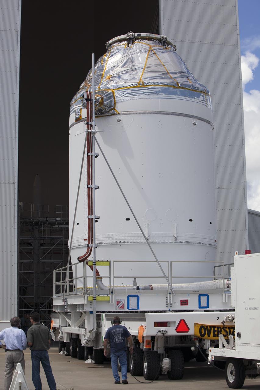 CAPE CANAVERAL, Fla. – The Orion crew module, stacked atop its service module, arrives at the Launch Abort System Facility, or LASF, at NASA's Kennedy Space Center in Florida. The spacecraft was moved from the Payload Hazardous Servicing Facility, where it was fueled ahead of its December flight test. In the LASF, the Launch Abort System will be installed around the Orion spacecraft. Orion is the exploration spacecraft designed to carry astronauts to destinations not yet explored by humans, including an asteroid and Mars. It will have emergency abort capability, sustain the crew during space travel and provide safe re-entry from deep space return velocities. The first unpiloted test flight of the Orion is scheduled to launch atop a United Launch Alliance Delta IV Heavy rocket from Cape Canaveral Air Force Station in Florida to an altitude of 3,600 miles above the Earth's surface. The two-orbit, four-hour flight test will help engineers evaluate the systems critical to crew safety including the heat shield, parachute system and launch abort system. For more information, visit http://www.nasa.gov/orion. Photo credit: NASA/Dimitri Gerondidakis