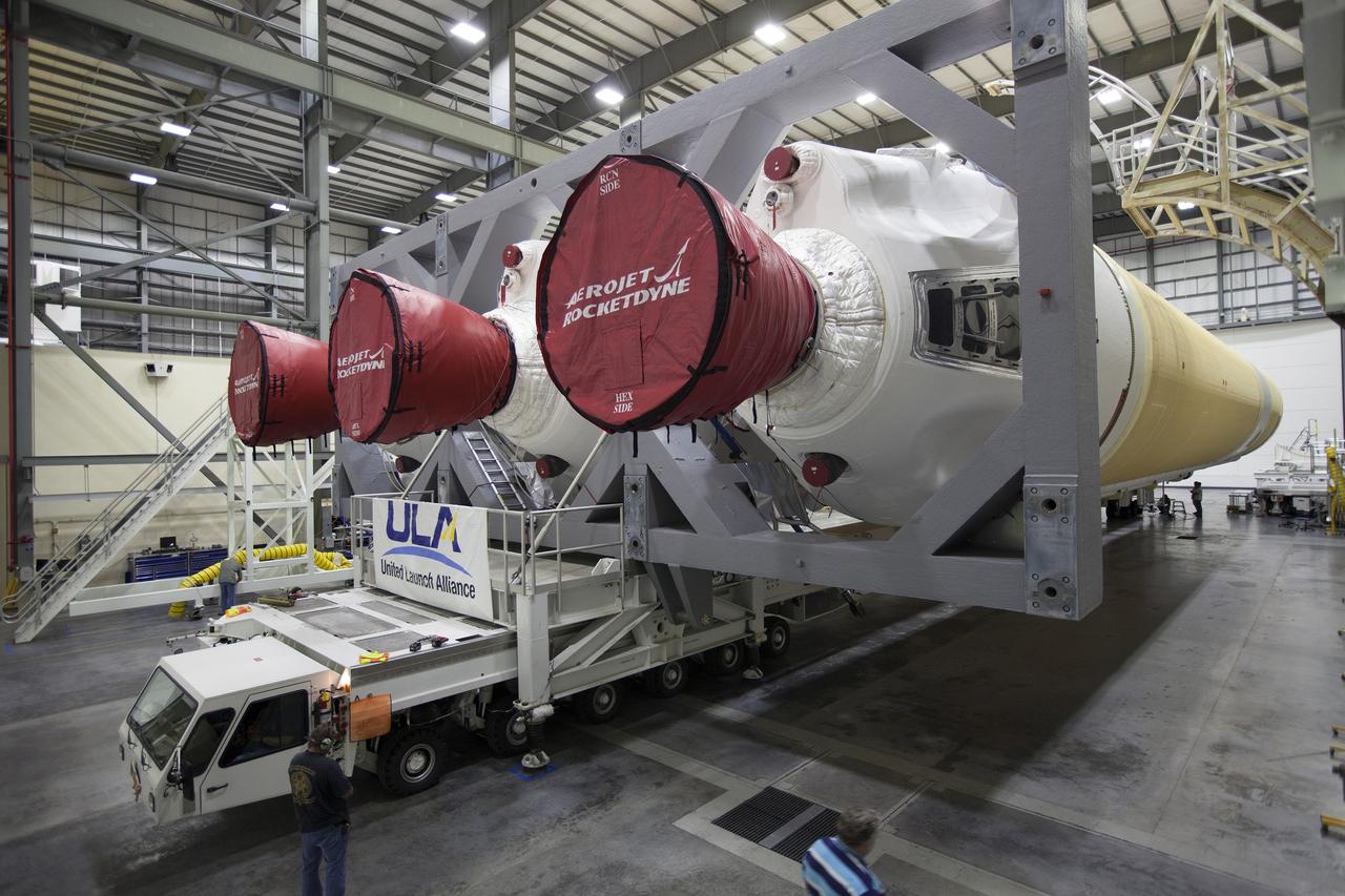 CAPE CANAVERAL, Fla. – Inside the Horizontal Integration Facility at Space Launch Complex 37 at Cape Canaveral Air Force Station in Florida, United Launch Alliance technicians prepare the Delta IV Heavy rocket for rollout to the pad. The rocket is secured on the Elevated Platform Transporter for the trip to the pad. The Delta IV Heavy will launch Orion on Exploration Flight Test-1. During its first flight test, Orion will travel farther into space than any human spacecraft has gone in more than 40 years. The data gathered during the flight will influence design decisions, validate existing computer models and innovative new approaches to space systems development, as well as reduce overall mission risks and costs for later Orion flights. Liftoff of Orion on the first flight test is planned for December 2014. Photo credit: NASA/Dimitri Gerondidakis