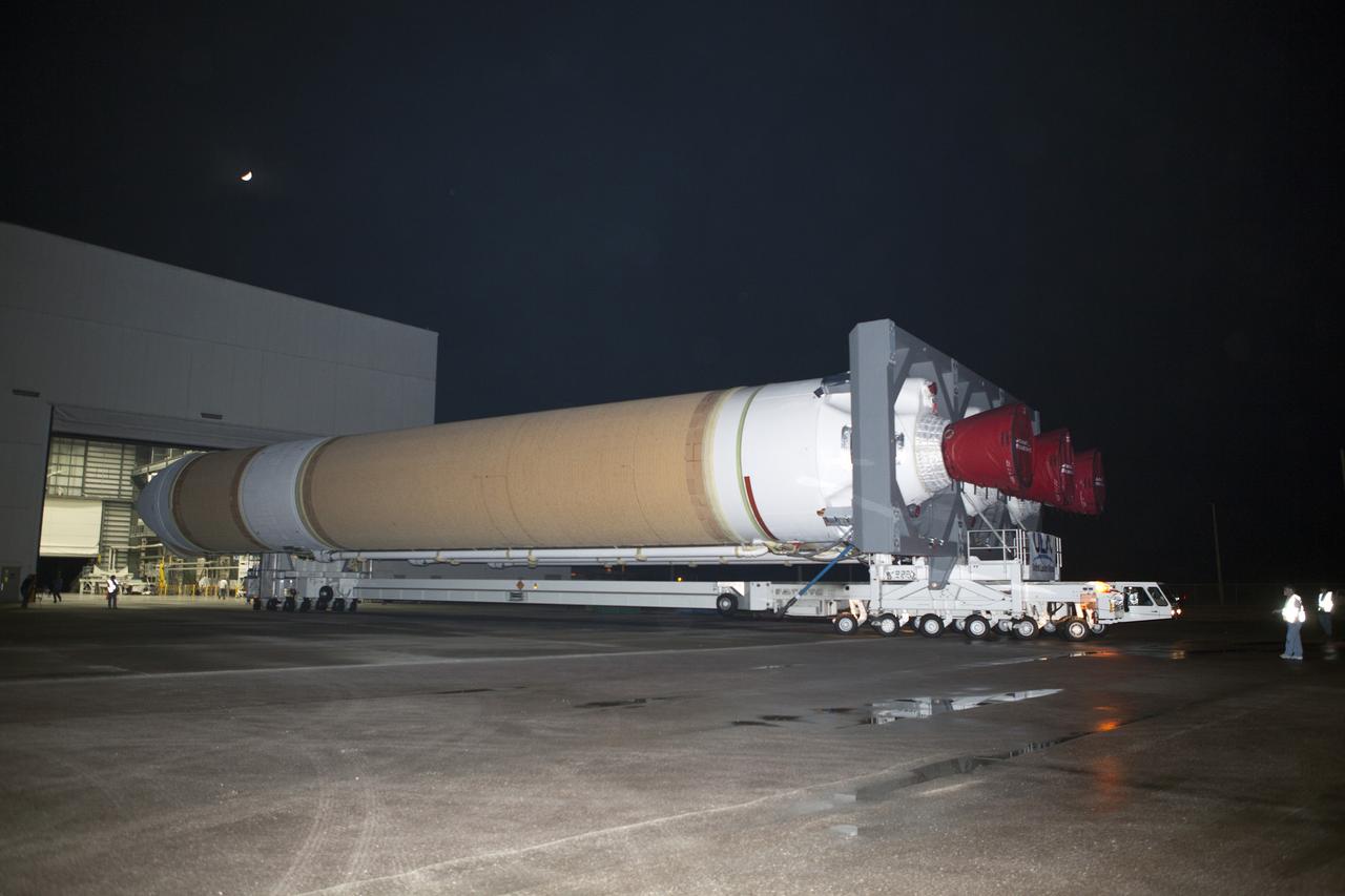 CAPE CANAVERAL, Fla. – The United Launch Alliance Delta IV Heavy rocket exits the Horizontal Integration Facility at Space Launch Complex 37 at Cape Canaveral Air Force Station in Florida. The rocket is secured on the Elevated Platform Transporter for the trip to the pad. The Delta IV Heavy will launch Orion on Exploration Flight Test-1. During its first flight test, Orion will travel farther into space than any human spacecraft has gone in more than 40 years. The data gathered during the flight will influence design decisions, validate existing computer models and innovative new approaches to space systems development, as well as reduce overall mission risks and costs for later Orion flights. Liftoff of Orion on the first flight test is planned for December 2014. Photo credit: NASA/Dimitri Gerondidakis