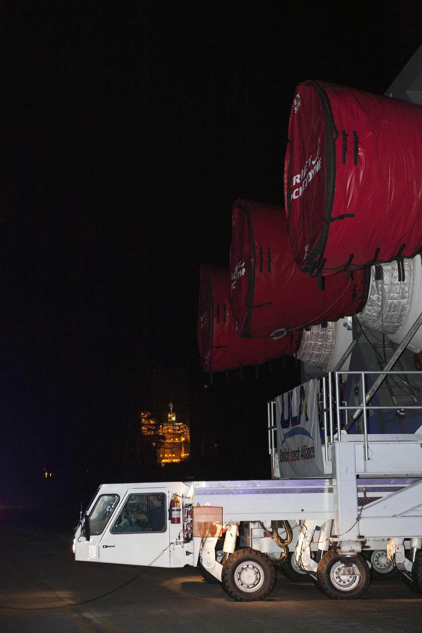 CAPE CANAVERAL, Fla. – A United Launch Alliance technicians drives the transporter that carries the Delta IV Heavy rocket to the pad at Space Launch Complex 37 at Cape Canaveral Air Force Station in Florida. The rocket is secured on the Elevated Platform Transporter. The Delta IV Heavy will launch Orion on Exploration Flight Test-1. During its first flight test, Orion will travel farther into space than any human spacecraft has gone in more than 40 years. The data gathered during the flight will influence design decisions, validate existing computer models and innovative new approaches to space systems development, as well as reduce overall mission risks and costs for later Orion flights. Liftoff of Orion on the first flight test is planned for December 2014. Photo credit: NASA/Dimitri Gerondidakis