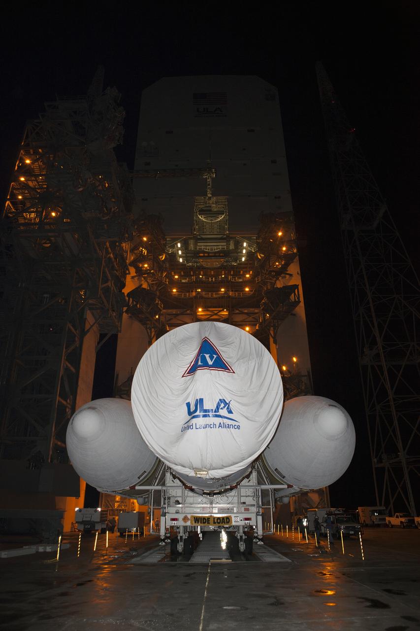 CAPE CANAVERAL, Fla. – Launch pad lights give off a golden glow at Space Launch Complex 37 at Cape Canaveral Air Force Station in Florida, as the United Launch Alliance Delta IV Heavy rocket for Exploration Flight Test-1 arrives. The rocket is secured on the Elevated Platform Transporter. The Delta IV Heavy will launch Orion on its first flight test. During its first flight test, Orion will travel farther into space than any human spacecraft has gone in more than 40 years. The data gathered during the flight will influence design decisions, validate existing computer models and innovative new approaches to space systems development, as well as reduce overall mission risks and costs for later Orion flights. Liftoff of Orion on the first flight test is planned for December 2014. Photo credit: NASA/Dimitri Gerondidakis