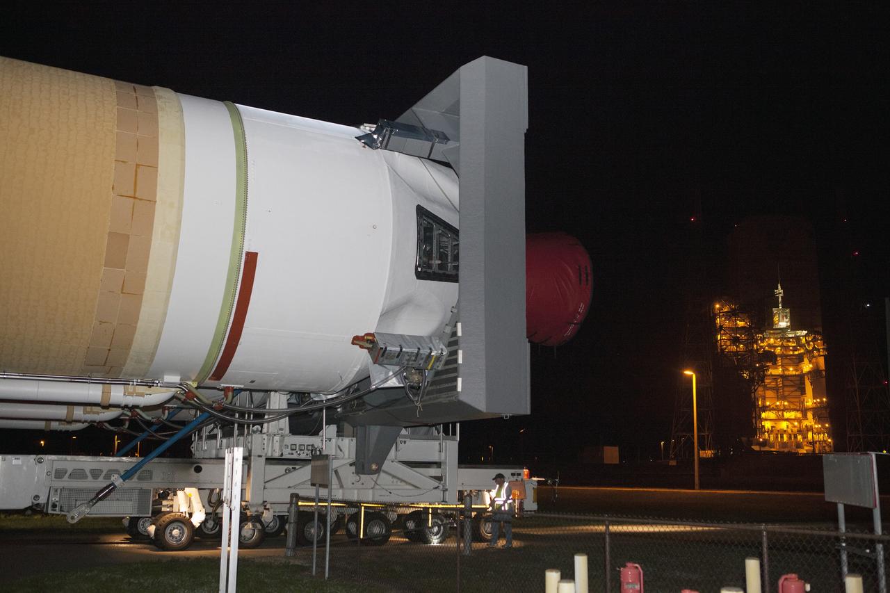 CAPE CANAVERAL, Fla. – The United Launch Alliance, or ULA, Delta IV Heavy rocket for Exploration Flight Test-1 continues its trek to the pad at Space Launch Complex 37 at Cape Canaveral Air Force Station in Florida. ULA technicians help guide the transporter to the pad. The rocket is secured on the Elevated Platform Transporter. The Delta IV Heavy will launch Orion on its first flight test. During its first flight test, Orion will travel farther into space than any human spacecraft has gone in more than 40 years. The data gathered during the flight will influence design decisions, validate existing computer models and innovative new approaches to space systems development, as well as reduce overall mission risks and costs for later Orion flights. Liftoff of Orion on the first flight test is planned for December 2014. Photo credit: NASA/Dimitri Gerondidakis