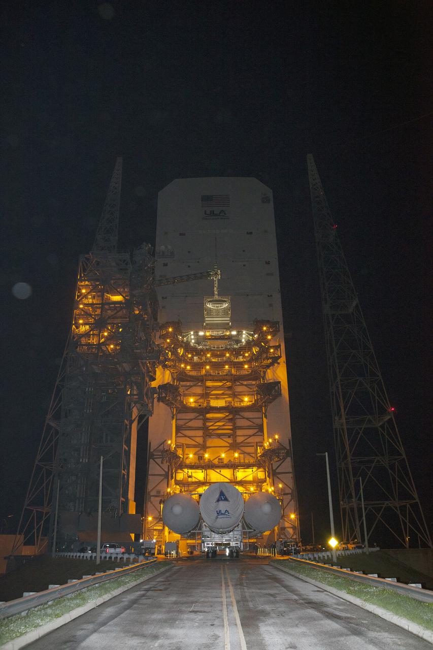 CAPE CANAVERAL, Fla. – Launch pad lights give off a golden glow at Space Launch Complex 37 at Cape Canaveral Air Force Station in Florida, as the United Launch Alliance Delta IV Heavy rocket for Exploration Flight Test-1 arrives. The rocket is secured on the Elevated Platform Transporter. The Delta IV Heavy will launch Orion on its first flight test. During its first flight test, Orion will travel farther into space than any human spacecraft has gone in more than 40 years. The data gathered during the flight will influence design decisions, validate existing computer models and innovative new approaches to space systems development, as well as reduce overall mission risks and costs for later Orion flights. Liftoff of Orion on the first flight test is planned for December 2014. Photo credit: NASA/Dimitri Gerondidakis
