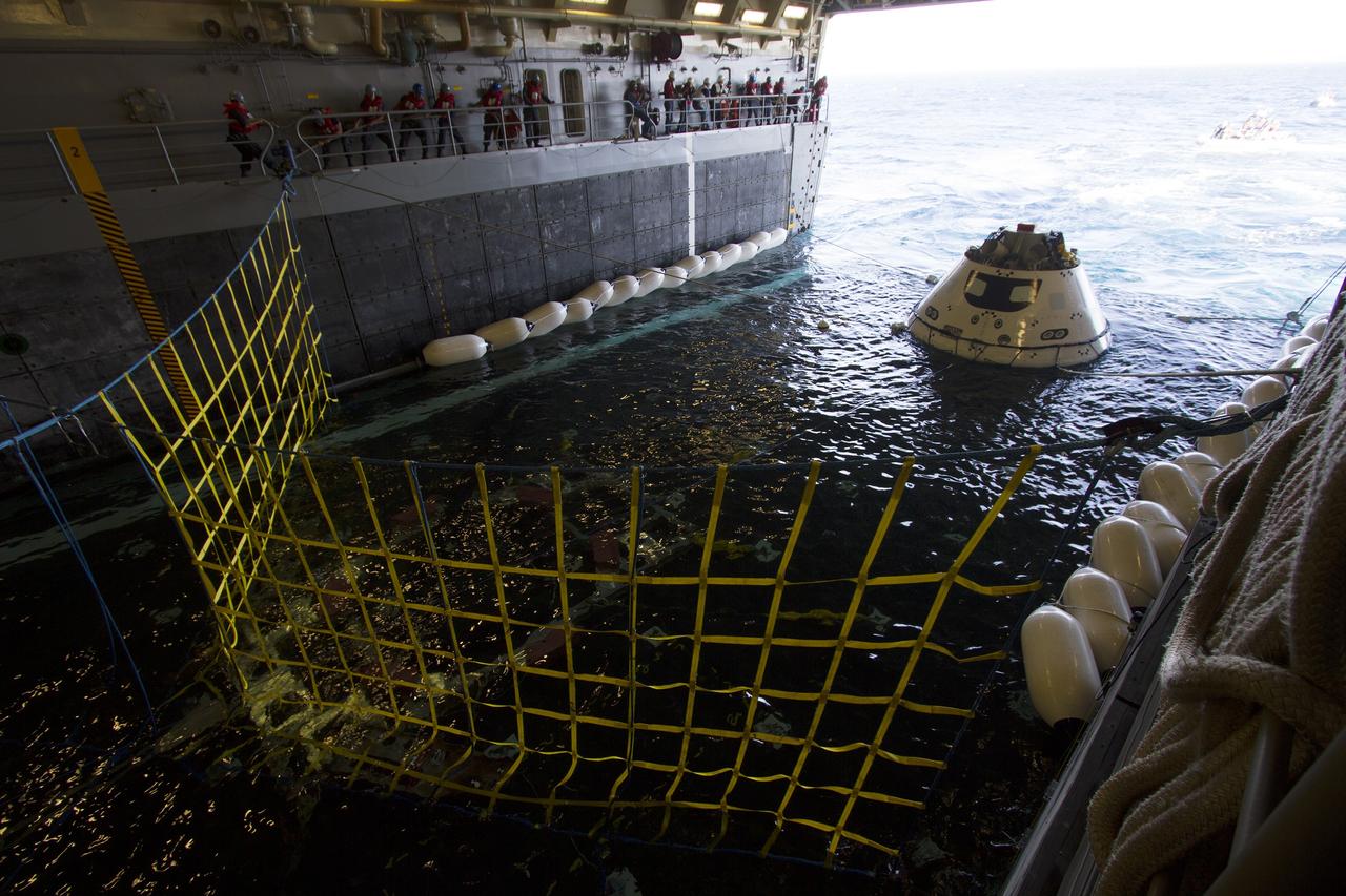 SAN DIEGO, Calif. – The Orion boilerplate test vehicle is in the water-filled well deck of the USS Anchorage during the first day of Underway Recovery Test 3 in the Pacific Ocean. NASA, Lockheed Martin and U.S. Navy personnel are conducting the recovery test to prepare for recovery of the Orion crew module on its return from a deep space mission. The test allows the teams to demonstrate and evaluate the recovery processes, procedures, hardware and personnel in open waters. The Ground Systems Development and Operations Program is conducting the underway recovery tests. Orion is the exploration spacecraft designed to carry astronauts to destinations not yet explored by humans, including an asteroid and Mars. It will have emergency abort capability, sustain the crew during space travel and provide safe re-entry from deep space return velocities. The first unpiloted test flight of Orion is scheduled to launch in 2014 atop a United Launch Alliance Delta IV Heavy rocket and in 2018 on NASA’s Space Launch System rocket. For more information, visit http://www.nasa.gov/orion. Photo credit: NASA/Cory Huston