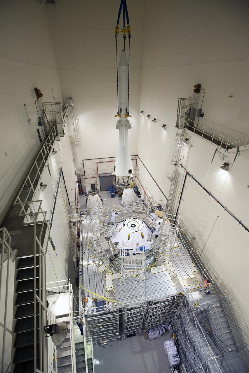 CAPE CANAVERAL, Fla. – A crane is used to move the launch abort system closer for installation on the Orion spacecraft for Exploration Flight Test-1 inside the Launch Abort System Facility, or LASF, at NASA's Kennedy Space Center in Florida. The completed crew and service modules will be tested and verified together with the launch abort system. Orion will remain inside the LASF until mid-November, when the United Launch Alliance Delta IV Heavy rocket is ready for integration with the spacecraft. Orion is the exploration spacecraft designed to carry astronauts to destinations not yet explored by humans, including an asteroid and Mars. It will have emergency abort capability, sustain the crew during space travel and provide safe re-entry from deep space return velocities. The first unpiloted test flight of the Orion is scheduled to launch in December atop the Delta IV Heavy rocket from Cape Canaveral Air Force Station in Florida to an altitude of 3,600 miles above the Earth's surface. The two-orbit, four-hour flight test will help engineers evaluate the systems critical to crew safety including the heat shield, parachute system and launch abort system. For more information, visit http://www.nasa.gov/orion. Photo credit: NASA/Cory Huston