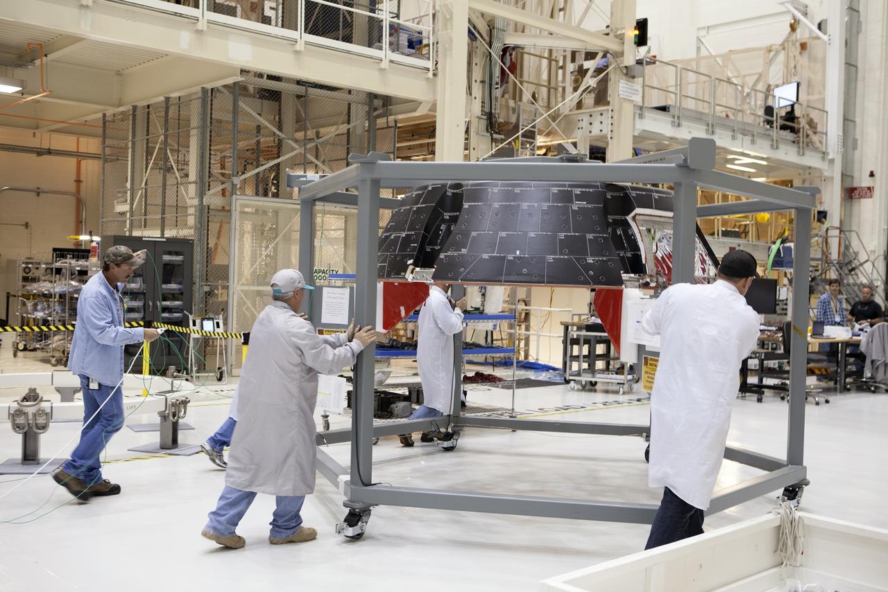CAPE CANAVERAL, Fla. – Inside the Neil Armstrong Operations and Checkout Building high bay at NASA’s Kennedy Space Center in Florida, Lockheed Martin technicians prepare to do a fit check of the forward bay cover for the Orion crew module. The cover is a shell that fits over Orion's crew module to protect the spacecraft during launch, orbital flight and re-entry into Earth's atmosphere. When Orion returns from space, the cover must be jettisoned high above the ground so that the parachutes can deploy and unfurl. Orion is the exploration spacecraft designed to carry astronauts to destinations not yet explored by humans, including an asteroid and Mars. It will have emergency abort capability, sustain the crew during space travel and provide safe re-entry from deep space return velocities. The first unpiloted flight test of Orion is scheduled to launch in December 2014 atop a United Launch Alliance Delta IV Heavy rocket and in 2018 on NASA’s Space Launch System rocket. For more information, visit http://www.nasa.gov/orion. Photo credit: NASA/Daniel Casper