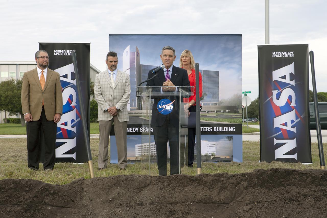 CAPE CANAVERAL, Fla. – Groundbreaking for the new Central Campus took place in the Industrial Area at NASA's Kennedy Space Center in Florida. Kennedy Center Director Bob Cabana speaks to members of the media and guests during the ceremony. Behind Cabana is Nancy Bray, director of Kennedy's Center Operations Directorate. From far left, are Steve Belflower, vice president of HuntonBrady Architects of Orlando, and Kirk Hazen, southeast district manager and vice president of Hensel Phelps, the construction contractor.     Kennedy is transforming into a multi-user, 21st century spaceport supporting both commercial and government users and operations. Central Campus Phase I includes construction of a new Headquarters Building as one of the major components of the strategy. The new Headquarters Building will be a seven-story, 200,000-square-foot facility that will house about 500 NASA civil service and contractor employees. Photo credit: NASA/Kim Shiflett