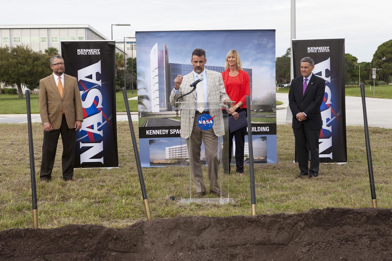 CAPE CANAVERAL, Fla. – Groundbreaking for the new Central Campus took place in the Industrial Area at NASA's Kennedy Space Center in Florida. Kirk Hazen, southeast district manager and vice president of Hensel Phelps, the construction contractor, speaks to members of the media and guests during the groundbreaking ceremony. Behind him is Nancy Bray, director of Kennedy's Center Operations Directorate. To his right is Kennedy Center Director Bob Cabana. To his left is Steve Belflower, vice president of HuntonBrady Architects of Orlando.      Kennedy is transforming into a multi-user, 21st century spaceport supporting both commercial and government users and operations. Central Campus Phase I includes construction of a new Headquarters Building as one of the major components of the strategy. The new Headquarters Building will be a seven-story, 200,000-square-foot facility that will house about 500 NASA civil service and contractor employees. Photo credit: NASA/Kim Shiflett
