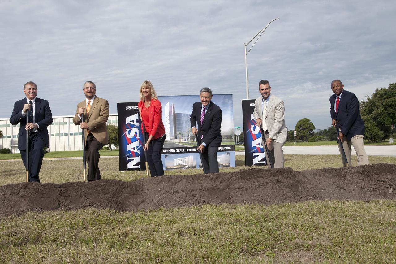 CAPE CANAVERAL, Fla. – Groundbreaking for the new Central Campus took place in the Industrial Area at NASA's Kennedy Space Center in Florida. Digging in with shovels during the groundbreaking ceremony, are Dan Tweed, associate director for Facilities at Kennedy Steve Belflower, vice president of HuntonBrady Architects of Orlando Nancy Bray, director of Kennedy's Center Operations Directorate Kennedy Center Director Bob Cabana Kirk Hazen, southeast district manager and vice president of Hensel Phelps, the construction contractor and Kelvin Manning, Kennedy's associate director.      Kennedy is transforming into a multi-user, 21st century spaceport supporting both commercial and government users and operations. Central Campus Phase I includes construction of a new Headquarters Building as one of the major components of the strategy. The new Headquarters Building will be a seven-story, 200,000-square-foot facility that will house about 500 NASA civil service and contractor employees. Photo credit: NASA/Kim Shiflett
