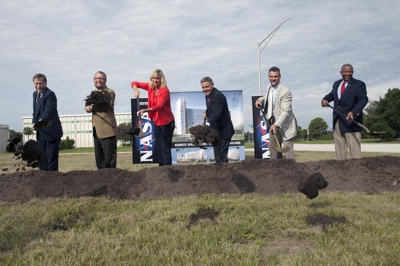 CAPE CANAVERAL, Fla. – Groundbreaking for the new Central Campus took place in the Industrial Area at NASA's Kennedy Space Center in Florida. Digging in with shovels during the groundbreaking ceremony, are Dan Tweed, associate director for Facilities at Kennedy Steve Belflower, vice president of HuntonBrady Architects of Orlando Nancy Bray, director of Kennedy's Center Operations Directorate Kennedy Center Director Bob Cabana Kirk Hazen, southeast district manager and vice president of Hensel Phelps, the construction contractor and Kelvin Manning, Kennedy's associate director.    Kennedy is transforming into a multi-user, 21st century spaceport supporting both commercial and government users and operations. Central Campus Phase I includes construction of a new Headquarters Building as one of the major components of the strategy. The new Headquarters Building will be a seven-story, 200,000-square-foot facility that will house about 500 NASA civil service and contractor employees. Photo credit: NASA/Kim Shiflett