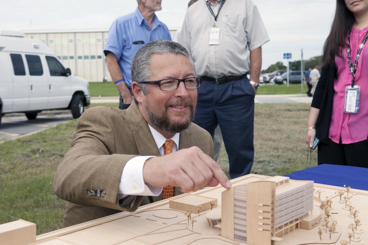 CAPE CANAVERAL, Fla. – Groundbreaking for the new Central Campus took place in the Industrial Area at NASA's Kennedy Space Center in Florida. Steve Belflower, vice president of HuntonBrady Architects of Orlando, points to a scale model of the Central Campus building on display during the groundbreaking ceremony.    Kennedy is transforming into a multi-user, 21st century spaceport supporting both commercial and government users and operations. Central Campus Phase I includes construction of a new Headquarters Building as one of the major components of the strategy. The new Headquarters Building will be a seven-story, 200,000-square-foot facility that will house about 500 NASA civil service and contractor employees. Photo credit: NASA/Kim Shiflett