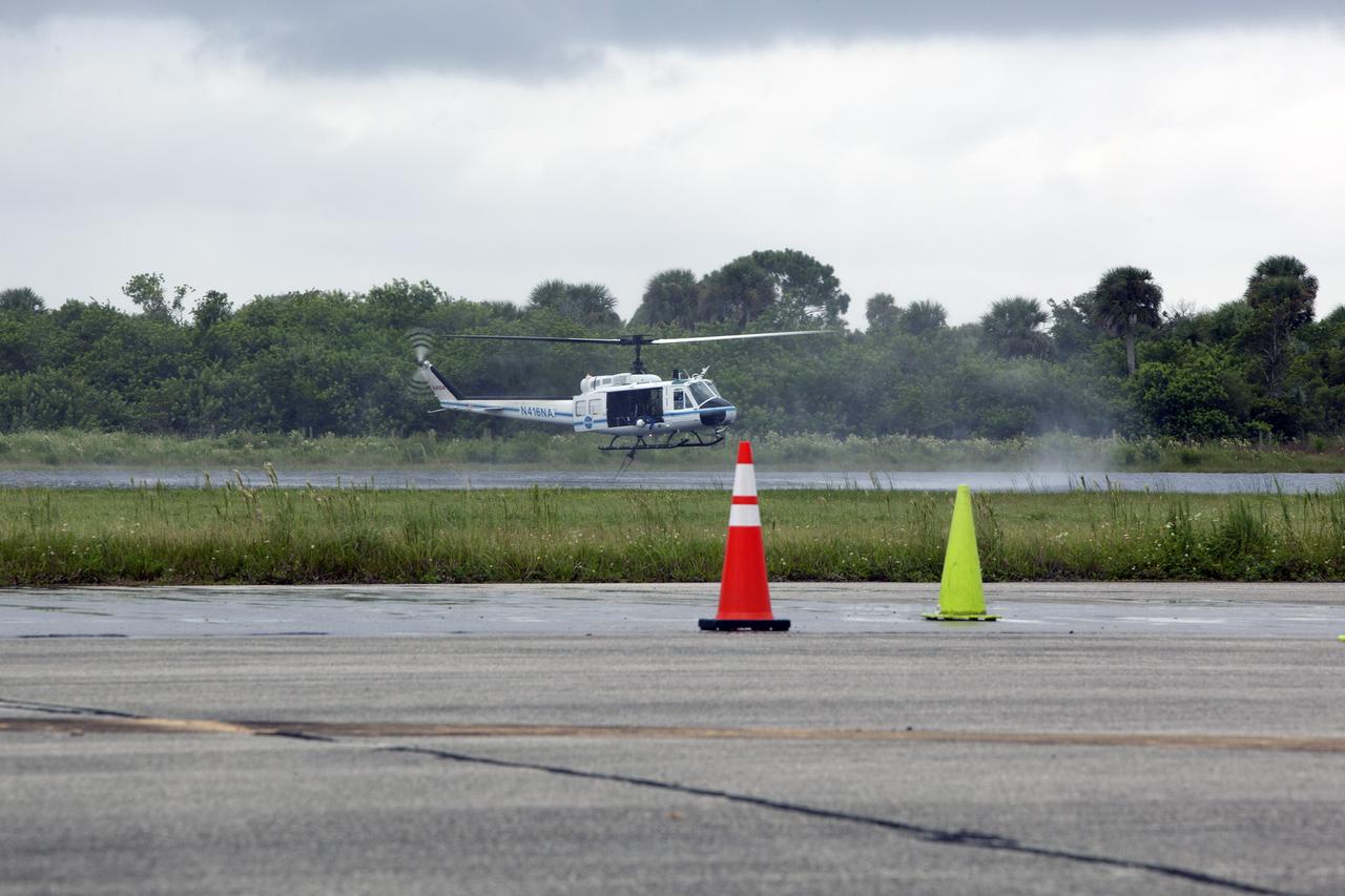 CAPE CANAVERAL, Fla. -- At NASA's Kennedy Space Center in Florida, the crew of the NASA helicopter carefully lowers a Bambi Bucket into a canal near the Shuttle Landing Facility. Minutes later, the water was dropped on the target cones in the foreground, using techniques that would be employed to fight a brush fire at the Kennedy Space Center. Firefighters respond to wildfires with teams on the ground and in the air. The most up-to-date tools include helicopters that use Bambi Buckets large quantities of water. NASA Flight Operations teams are training to perfect the skills needed to ensure they are ready to use tools, such as the Bambi Bucket, in the event of an out-of-control blaze at the spaceport. Photo credit: NASA/Frankie Martin