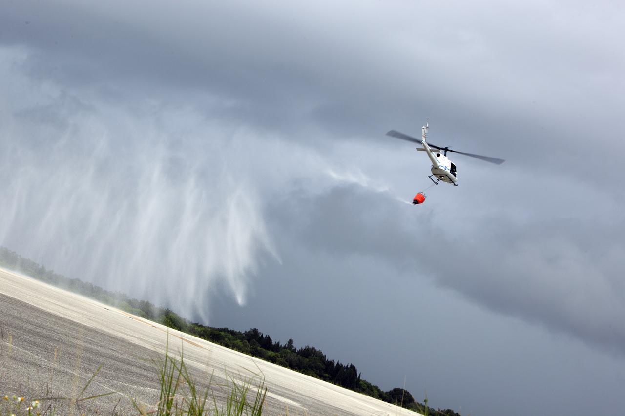 CAPE CANAVERAL, Fla. -- At NASA's Kennedy Space Center in Florida, a three-person helicopter crew recently practiced using a Bambi Bucket to pick up water from a nearby waterway and dropping it on simulated targets at the center’s Shuttle Landing Facility. Firefighters respond to wildfires with teams on the ground and in the air. The most up-to-date tools include helicopters that use Bambi Buckets large quantities of water. NASA Flight Operations teams are training to perfect the skills needed to ensure they are ready to use tools, such as the Bambi Bucket, in the event of an out-of-control blaze at the spaceport. Photo credit: NASA/Frankie Martin
