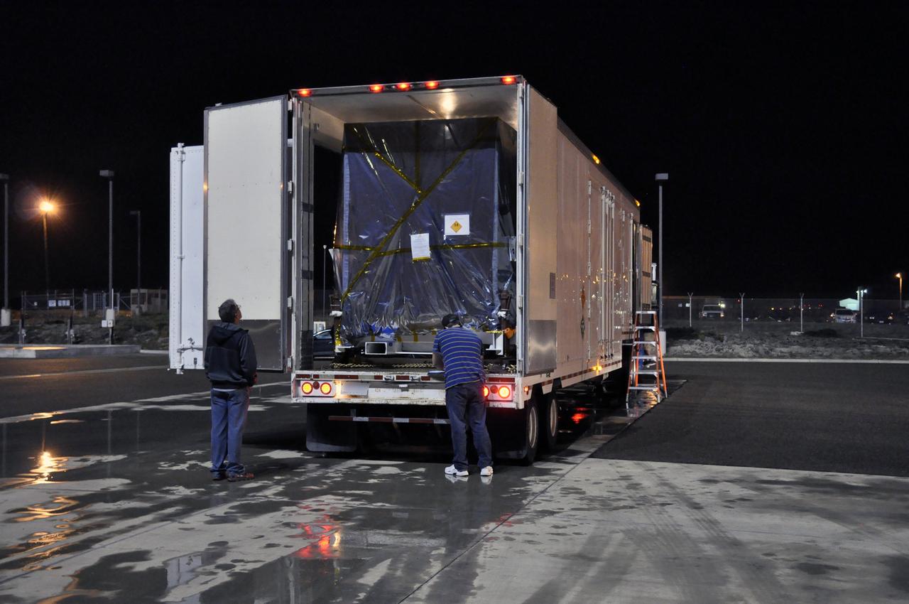 VANDENBERG AIR FORCE BASE, Calif. – Workers prepare to offload NASA's Soil Moisture Active Passive, or SMAP, spacecraft from the truck that delivered it from the Jet Propulsion Laboratory in Pasadena, California, to the Astrotech payload processing facility on Vandenberg Air Force Base in California.    SMAP will launch on a Delta II 7320 configuration vehicle featuring a United Launch Alliance first stage booster powered by an Aerojet Rocketdyne RS-27A main engine and three Alliant Techsystems, or ATK, strap-on solid rocket motors. Once on station in Earth orbit, SMAP will provide global measurements of soil moisture and its freeze/thaw state. These measurements will be used to enhance understanding of processes that link the water, energy and carbon cycles, and to extend the capabilities of weather and climate prediction models. SMAP data also will be used to quantify net carbon flux in boreal landscapes and to develop improved flood prediction and drought monitoring capabilities. Launch from Space Launch Complex 2 is targeted for Jan. 29, 2015. To learn more about SMAP, visit http://smap.jpl.nasa.gov.  Photo credit: NASA/Randy Beaudoin
