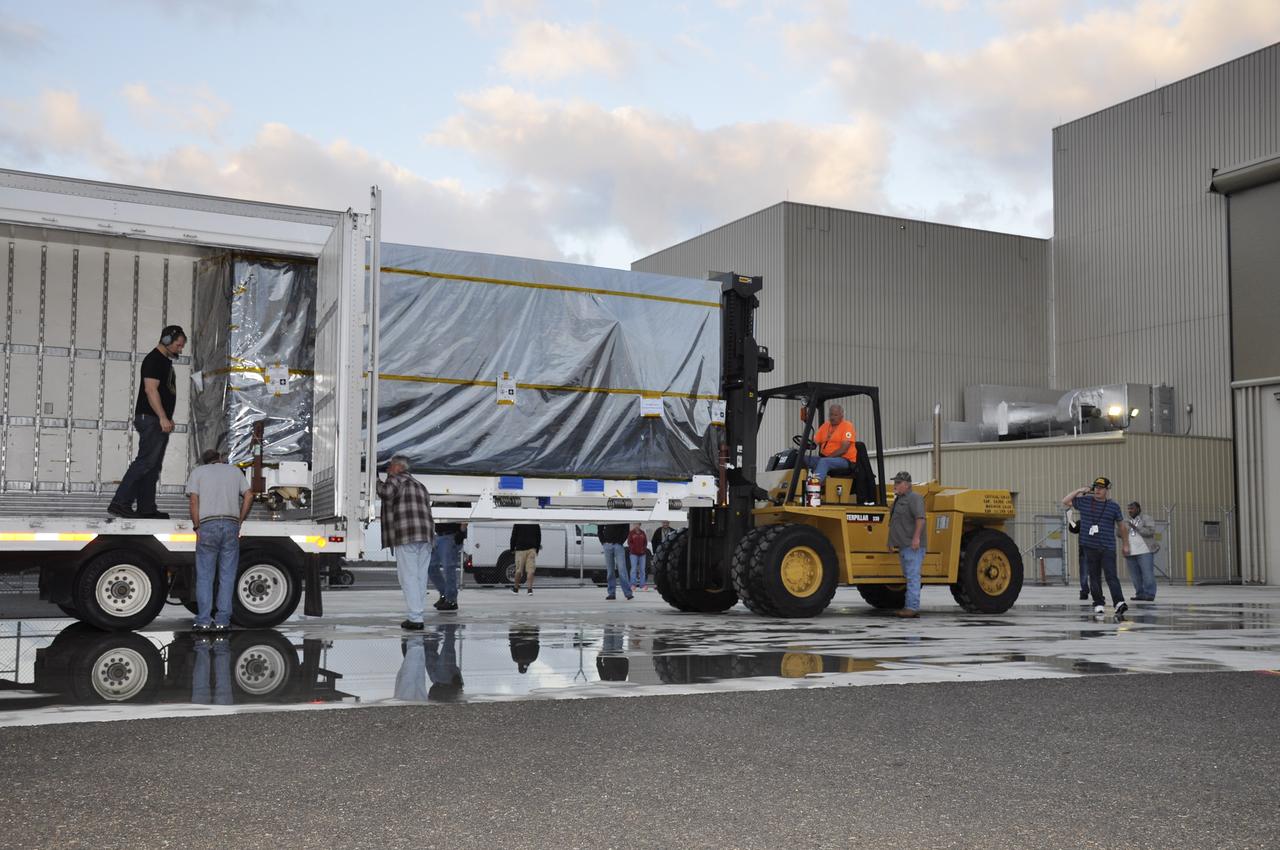 VANDENBERG AIR FORCE BASE, Calif. – NASA's Soil Moisture Active Passive, or SMAP, spacecraft is delivered by truck to the Astrotech payload processing facility on Vandenberg Air Force Base in California.    SMAP will launch on a Delta II 7320 configuration vehicle featuring a United Launch Alliance first stage booster powered by an Aerojet Rocketdyne RS-27A main engine and three Alliant Techsystems, or ATK, strap-on solid rocket motors. Once on station in Earth orbit, SMAP will provide global measurements of soil moisture and its freeze/thaw state. These measurements will be used to enhance understanding of processes that link the water, energy and carbon cycles, and to extend the capabilities of weather and climate prediction models. SMAP data also will be used to quantify net carbon flux in boreal landscapes and to develop improved flood prediction and drought monitoring capabilities. Launch from Space Launch Complex 2 is targeted for Jan. 29, 2015. To learn more about SMAP, visit http://smap.jpl.nasa.gov.  Photo credit: NASA/Randy Beaudoin