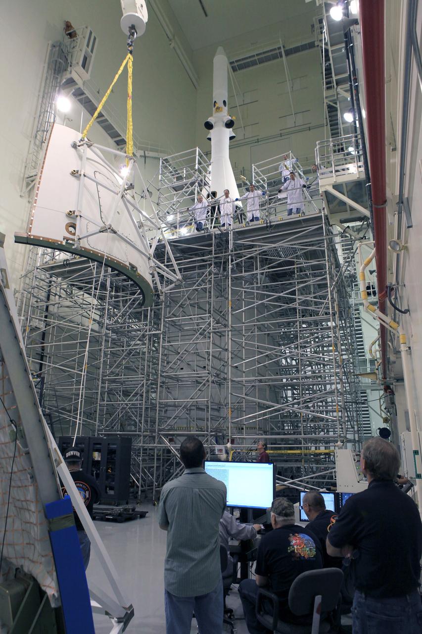 CAPE CANAVERAL, Fla. – The first of four Ogive panels is lifted by crane for installation on Orion's Launch Abort System inside the Launch Abort System Facility at NASA’s Kennedy Space Center in Florida. The panels will smooth the airflow over the conical spacecraft to limit sound and vibration, which will make for a much smoother ride for the astronauts who will ride inside Orion in the future. The work marked the final major assembly steps for the spacecraft before it is transported to Space Launch Complex 37 at Cape Canaveral Air Force Station in November. Orion is the exploration spacecraft designed to carry astronauts to destinations not yet explored by humans, including an asteroid and Mars. It will have emergency abort capability, sustain the crew during space travel and provide safe re-entry from deep space return velocities. The first unpiloted flight test of Orion is scheduled to launch in December 2014 atop a United Launch Alliance Delta IV Heavy rocket, and in 2018 on NASA’s Space Launch System rocket. For more information, visit www.nasa.gov/orion. Photo credit: Kim Shiflett