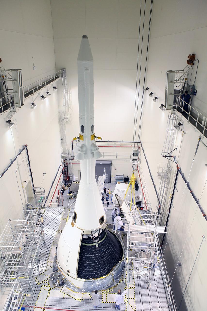 CAPE CANAVERAL, Fla. – Installation of four Ogive panels on Orion's Launch Abort System continues inside the Launch Abort System Facility at NASA’s Kennedy Space Center in Florida. The panels will smooth the airflow over the conical spacecraft to limit sound and vibration, which will make for a much smoother ride for the astronauts who will ride inside Orion in the future. The work marked the final major assembly steps for the spacecraft before it is transported to Space Launch Complex 37 at Cape Canaveral Air Force Station in November. Orion is the exploration spacecraft designed to carry astronauts to destinations not yet explored by humans, including an asteroid and Mars. It will have emergency abort capability, sustain the crew during space travel and provide safe re-entry from deep space return velocities. The first unpiloted flight test of Orion is scheduled to launch in December 2014 atop a United Launch Alliance Delta IV Heavy rocket, and in 2018 on NASA’s Space Launch System rocket. For more information, visit www.nasa.gov/orion. Photo credit: Daniel Casper
