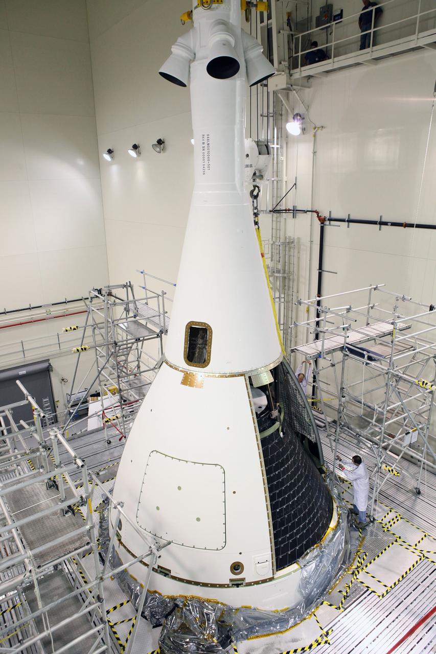CAPE CANAVERAL, Fla. – Inside the Launch Abort System Facility at NASA’s Kennedy Space Center in Florida, technicians have installed two of the four Ogive panels on Orion's Launch Abort System. The panels will smooth the airflow over the conical spacecraft to limit sound and vibration, which will make for a much smoother ride for the astronauts who will ride inside Orion in the future. The work marked the final major assembly steps for the spacecraft before it is transported to Space Launch Complex 37 at Cape Canaveral Air Force Station in November. Orion is the exploration spacecraft designed to carry astronauts to destinations not yet explored by humans, including an asteroid and Mars. It will have emergency abort capability, sustain the crew during space travel and provide safe re-entry from deep space return velocities. The first unpiloted flight test of Orion is scheduled to launch in December 2014 atop a United Launch Alliance Delta IV Heavy rocket, and in 2018 on NASA’s Space Launch System rocket. For more information, visit www.nasa.gov/orion. Photo credit: Daniel Casper