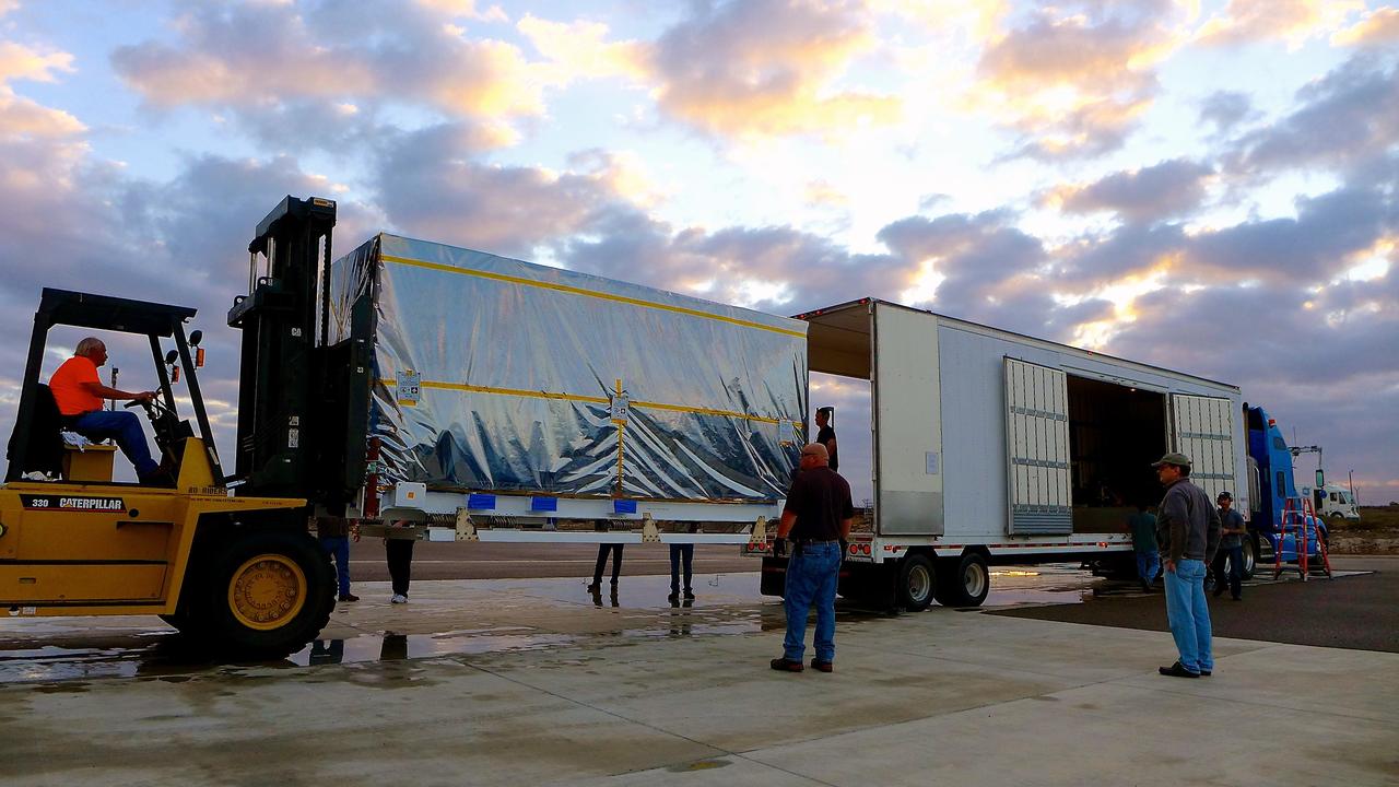 VANDENBERG AIR FORCE BASE, Calif. – A forklift is enlisted to offload the transportation container protecting NASA's Soil Moisture Active Passive, or SMAP, spacecraft from the truck that delivered it from the Jet Propulsion Laboratory in Pasadena, California, to the Astrotech payload processing facility on Vandenberg Air Force Base in California.    SMAP will launch on a Delta II 7320 configuration vehicle featuring a United Launch Alliance first stage booster powered by an Aerojet Rocketdyne RS-27A main engine and three Alliant Techsystems, or ATK, strap-on solid rocket motors. Once on station in Earth orbit, SMAP will provide global measurements of soil moisture and its freeze/thaw state. These measurements will be used to enhance understanding of processes that link the water, energy and carbon cycles, and to extend the capabilities of weather and climate prediction models. SMAP data also will be used to quantify net carbon flux in boreal landscapes and to develop improved flood prediction and drought monitoring capabilities. Launch from Space Launch Complex 2 is targeted for Jan. 29, 2015. To learn more about SMAP, visit http://smap.jpl.nasa.gov.  Photo credit: NASA/Stephen Greenberg, JPL