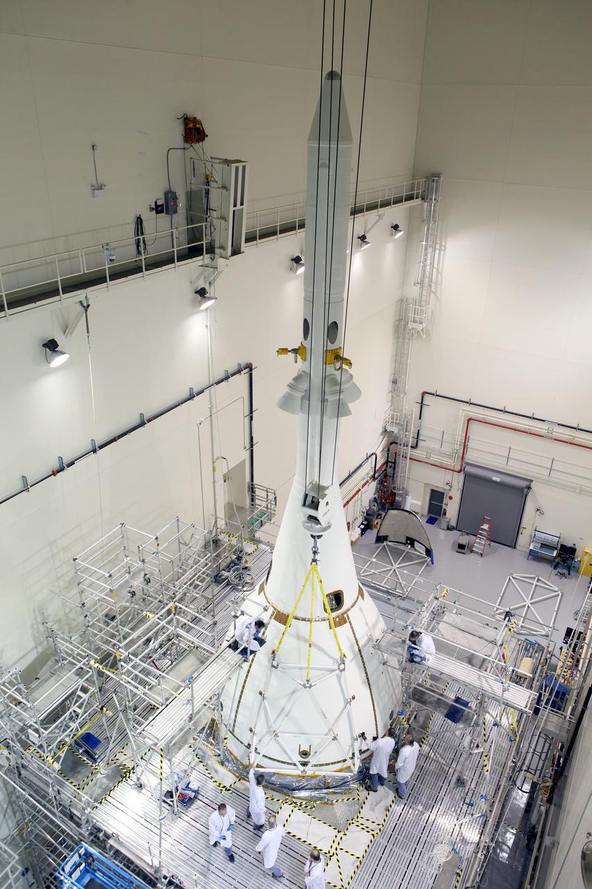 CAPE CANAVERAL, Fla. – Inside the Launch Abort System Facility at NASA’s Kennedy Space Center in Florida, technicians attach the third of four Ogive panels on Orion's Launch Abort System. The panels will smooth the airflow over the conical spacecraft to limit sound and vibration, which will make for a much smoother ride for the astronauts who will ride inside Orion in the future. The work marked the final major assembly steps for the spacecraft before it is transported to Space Launch Complex 37 at Cape Canaveral Air Force Station in November. Orion is the exploration spacecraft designed to carry astronauts to destinations not yet explored by humans, including an asteroid and Mars. It will have emergency abort capability, sustain the crew during space travel and provide safe re-entry from deep space return velocities. The first unpiloted flight test of Orion is scheduled to launch in December 2014 atop a United Launch Alliance Delta IV Heavy rocket, and in 2018 on NASA’s Space Launch System rocket. For more information, visit www.nasa.gov/orion. Photo credit: Ben Smegelsky