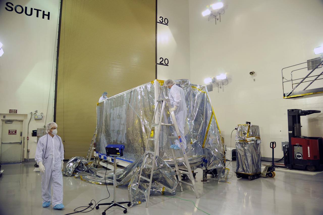 VANDENBERG AIR FORCE BASE, Calif. – Preparations are underway to remove the protective covering from NASA's Soil Moisture Active Passive, or SMAP, spacecraft in the Astrotech payload processing facility on Vandenberg Air Force Base in California during a post-shipment inspection. The covering protects the spacecraft from static-charge buildup and contamination.    SMAP will launch on a Delta II 7320 configuration vehicle featuring a United Launch Alliance first stage booster powered by an Aerojet Rocketdyne RS-27A main engine and three Alliant Techsystems, or ATK, strap-on solid rocket motors. Once on station in Earth orbit, SMAP will provide global measurements of soil moisture and its freeze/thaw state. These measurements will be used to enhance understanding of processes that link the water, energy and carbon cycles, and to extend the capabilities of weather and climate prediction models. SMAP data also will be used to quantify net carbon flux in boreal landscapes and to develop improved flood prediction and drought monitoring capabilities. Launch from Space Launch Complex 2 is targeted for Jan. 29, 2015. To learn more about SMAP, visit http://smap.jpl.nasa.gov.  Photo credit: NASA/Robert Rasmison